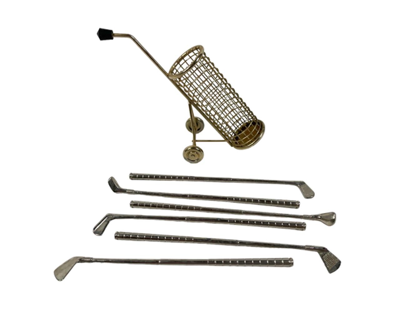 Vintage golf themed swizzle stick / cocktail stirrer / muddler set. Six stainless golf club stirrers/muddlers with a gold tone golf bag of wire mesh and resting on a pair of wheels. 