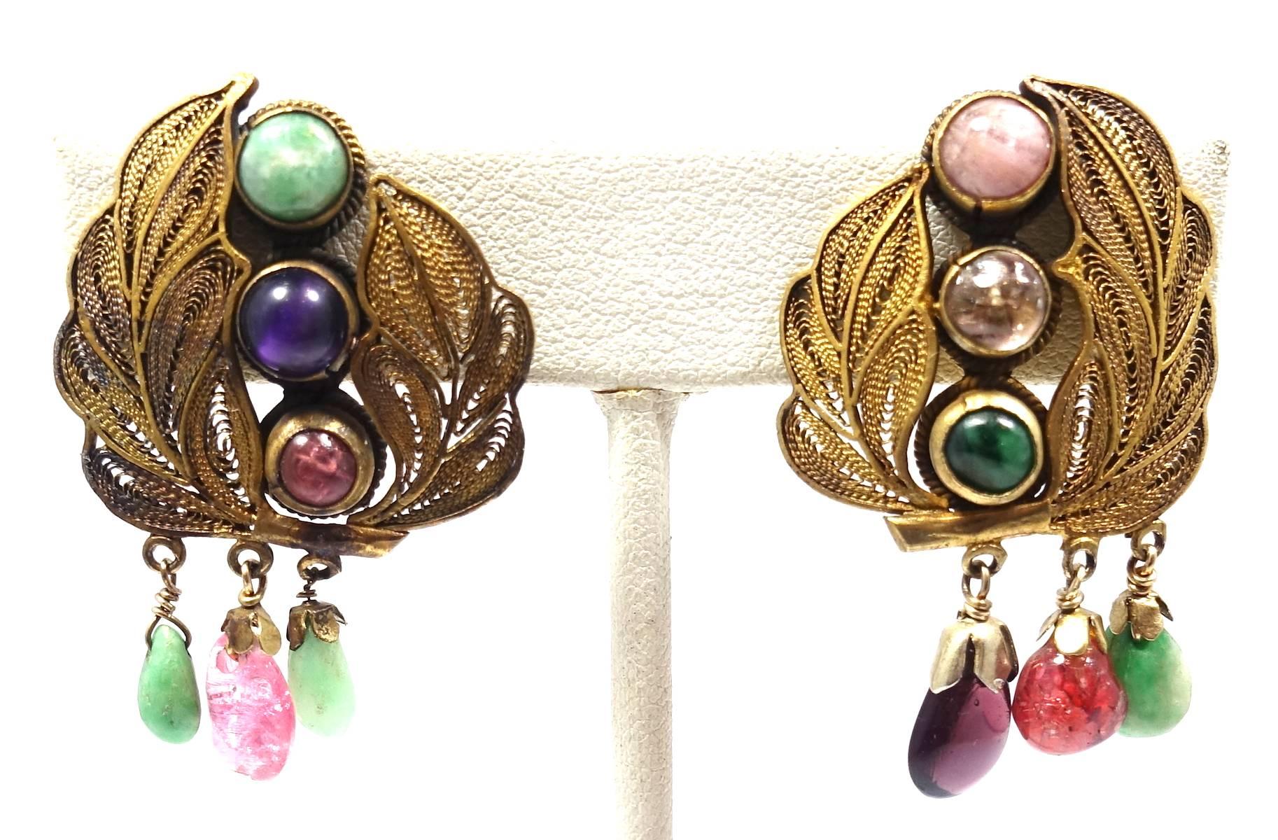 These “Good Luck” all original vintage clip earrings feature multiple genuine gemstones in an open work floral leaf design in sterling silver with a gold vermeil. These clip earrings measure 1-1/2” x 1” and are in excellent condition.