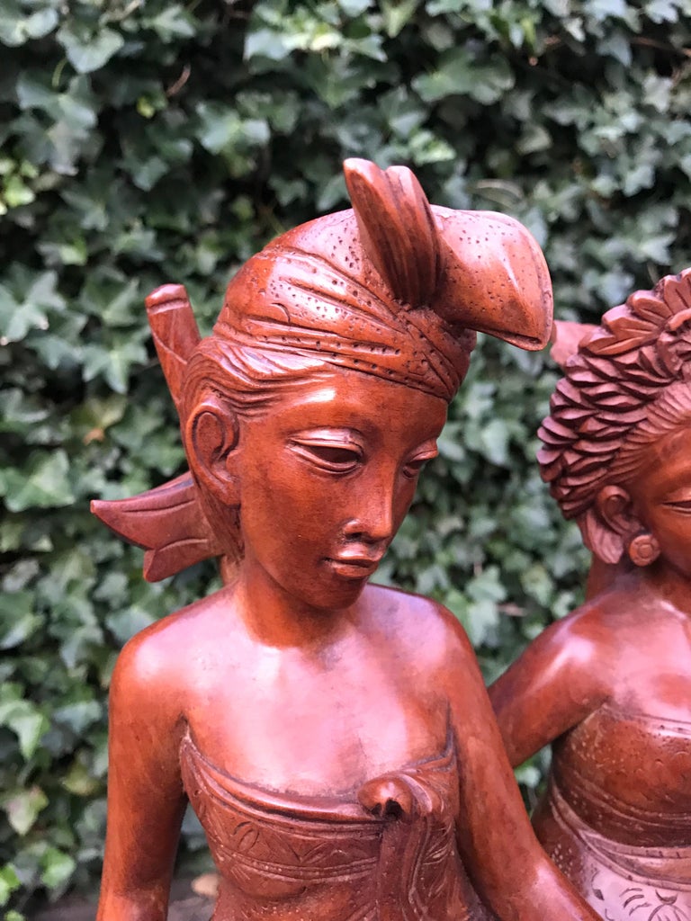 Artistically carved sculpture of newly weds from 1940-1950.

This beautifully executed and romantic sculpture is of a madly in love Balinese male and female. This all-handcarved out of a dense hardwood work of art has the most beautiful and warm