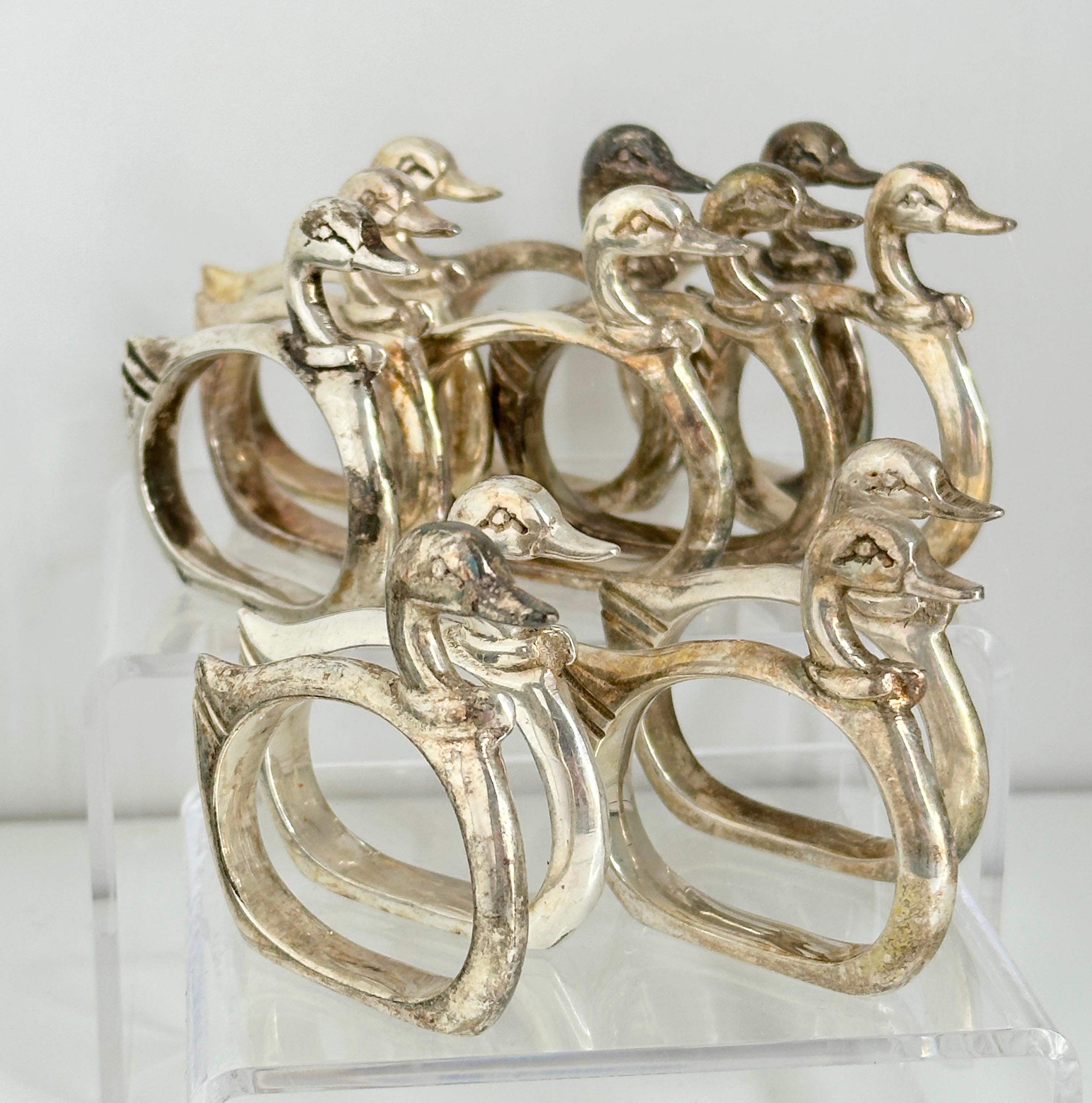 A set of twelve silver plated napkin rings, circa 1960s, made by unknown company. A nice set of round rings, in the style of the Art Nouveau era. All of them with a nice patina. Can be cleaned from the new owner, but also give the table a classic