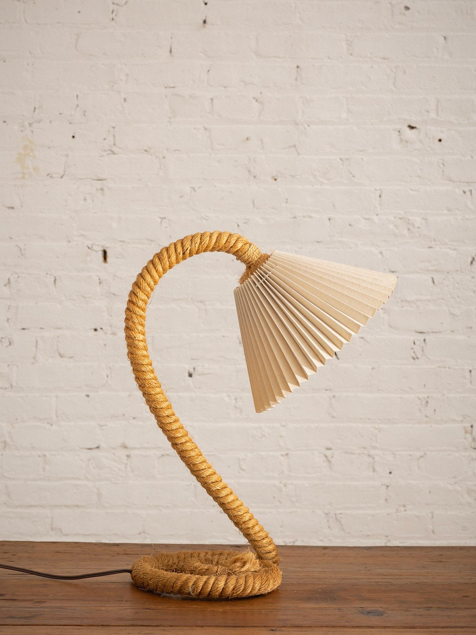 A vintage rope wrapped table lamp. In the style of Adrien Audoux and Frida Minet. Gooseneck silhouette with spiral base. Frayed rope edges are inherent to the lamp design. Lamp shade not included.