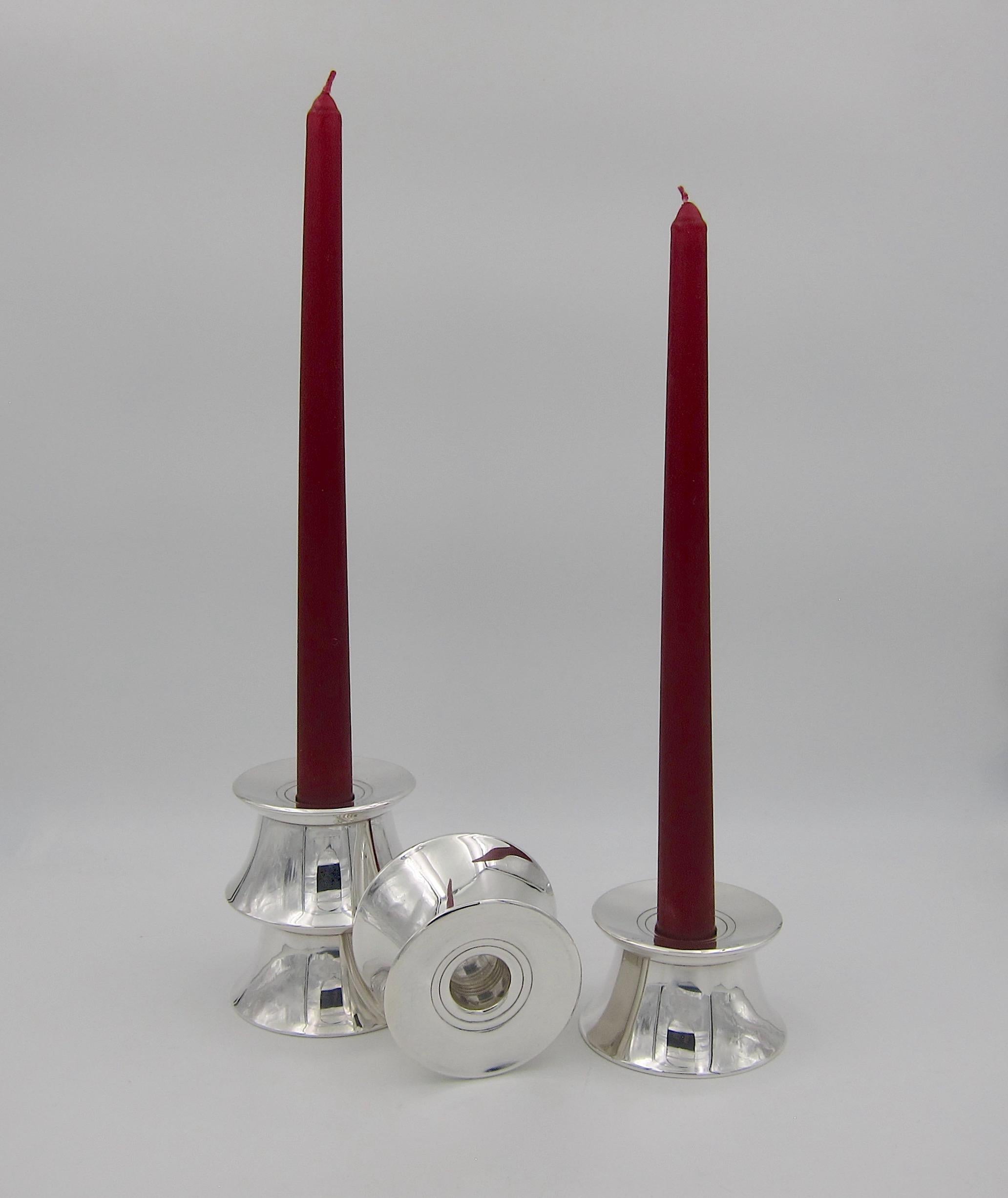 A set of four midcentury sterling silver candleholders from Gorham Manufacturing Company of Providence, Rhode Island. Gorham produced this Minimalist and customizable design in the 1950s for a line of modern silver hollowware called 