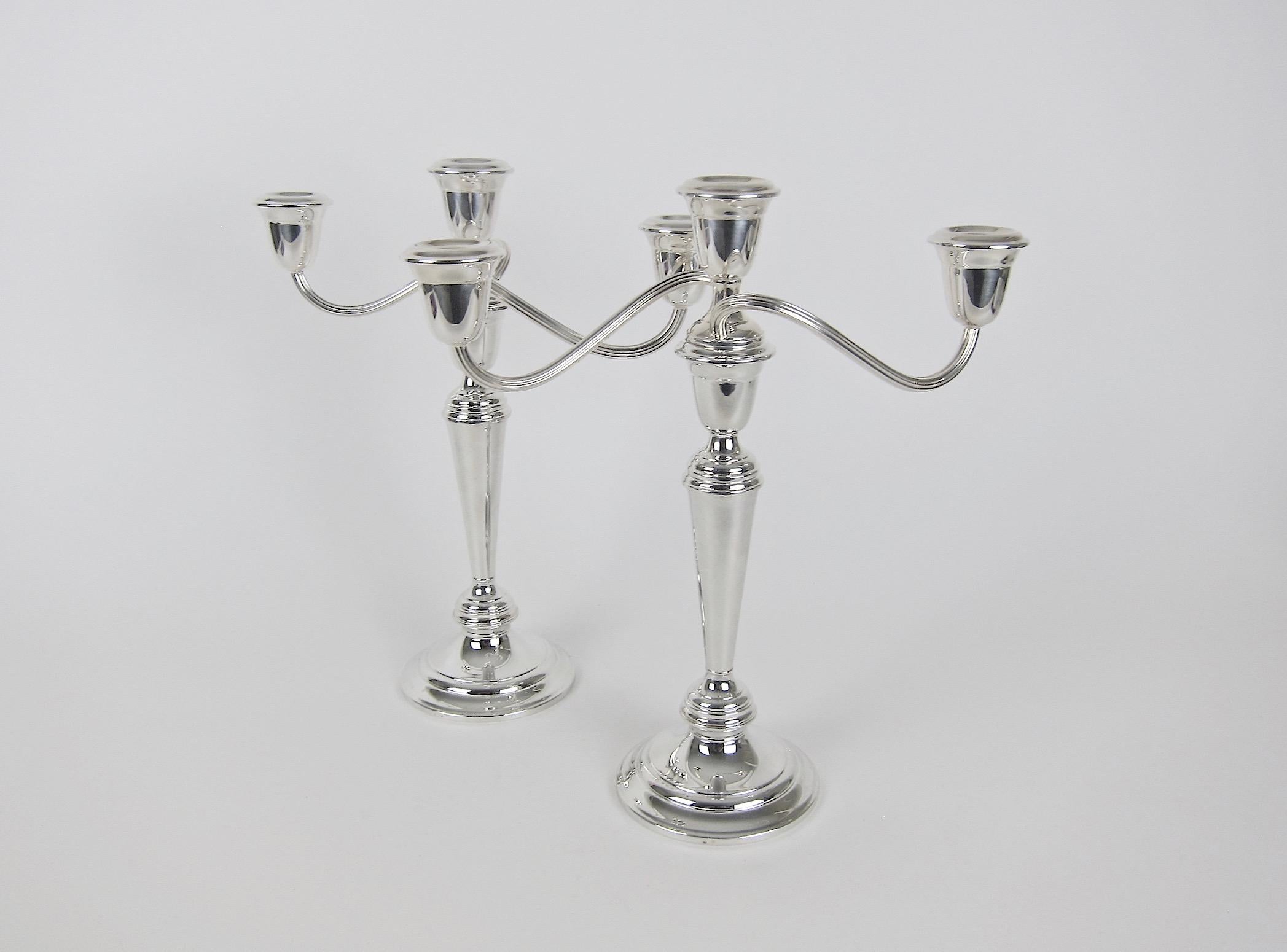 A vintage convertible three light candelabra pair from Gorham Manufacturing Company of Providence, Rhode Island. The silver plated candleholders are each composed of four parts: a weighted circular base, a tapering stem, an urn, and reeded twisting
