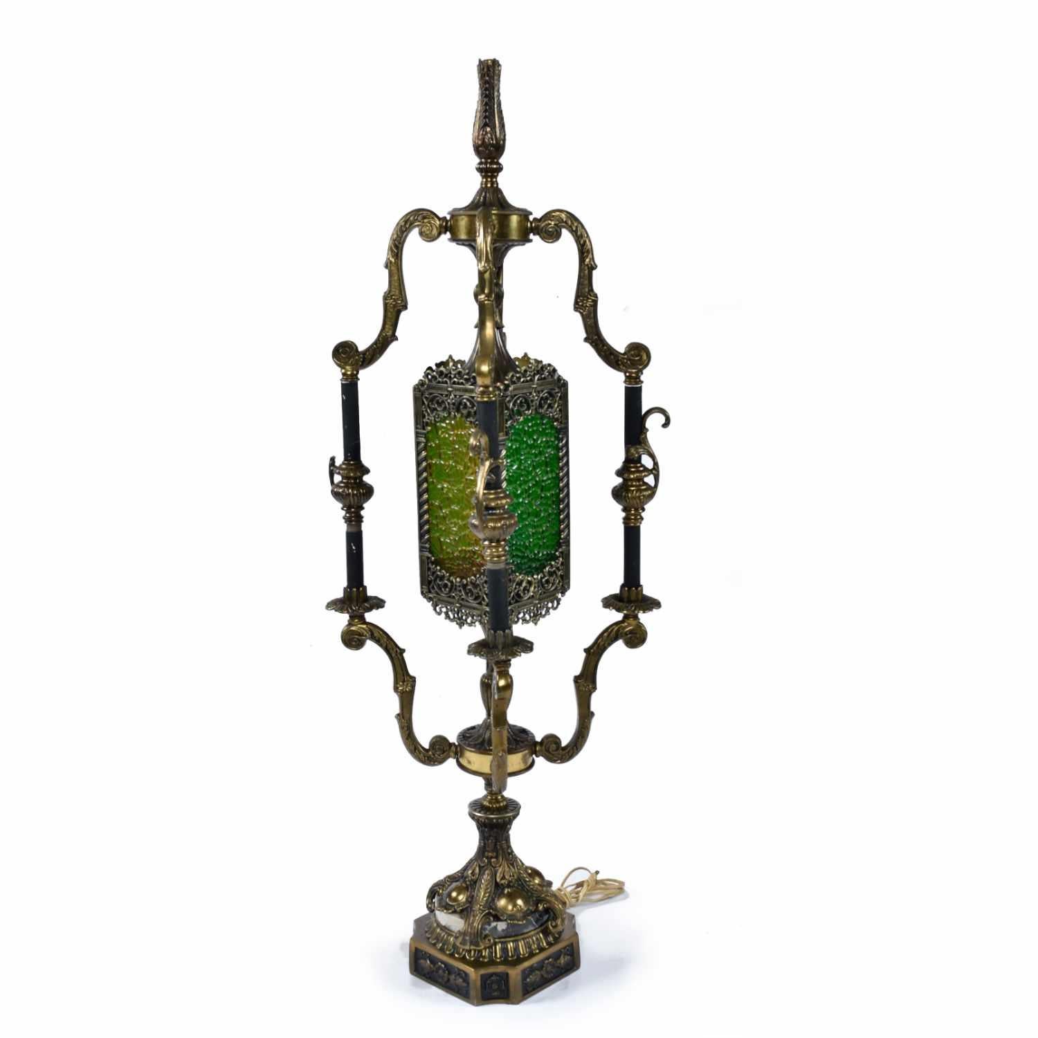 Vintage 1960s Mediterranean Gothic Revival table lamp. Fanciful scroll work, detailed embossed patterns, throughout and gold colored metal contrasting with black spires give a distinct Baroque feel. These elaborate embellishments along with the