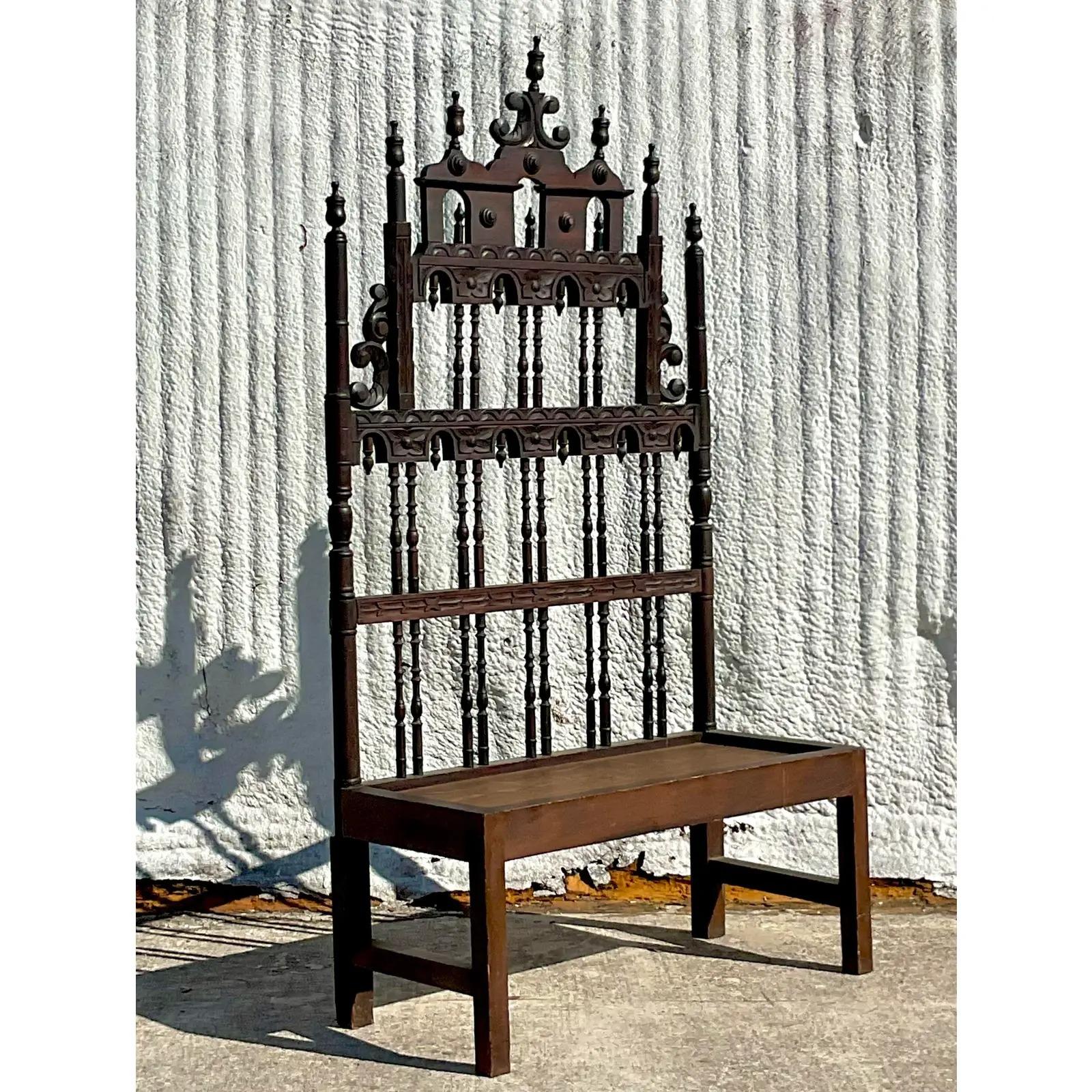 A fabulous vintage Gothic hand carved bench. A chic high back and wide seat. Perfect to add a little drama to any space. Acquired from a Palm Beach estate.