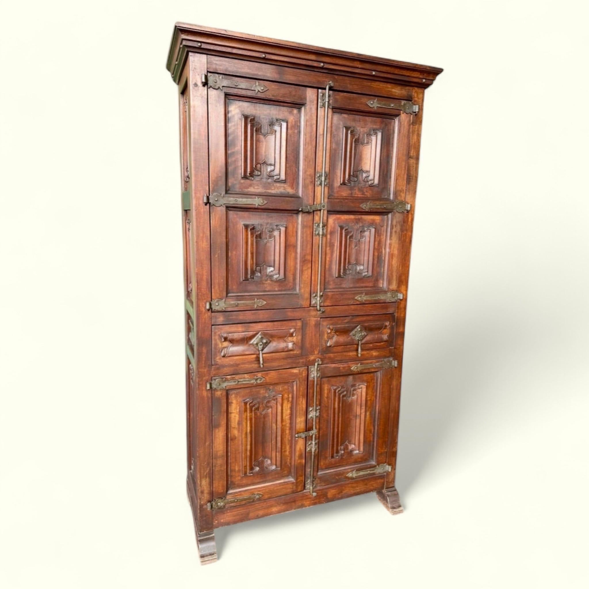 Vintage Gothic Revival Carved Wood and Iron Cabinet.

Procured from a well-traveled couple that appreciated a variety of styles. This cabinet is a great call to the design of the earlier medieval centuries. Hard to pinpoint a year, but we imagine