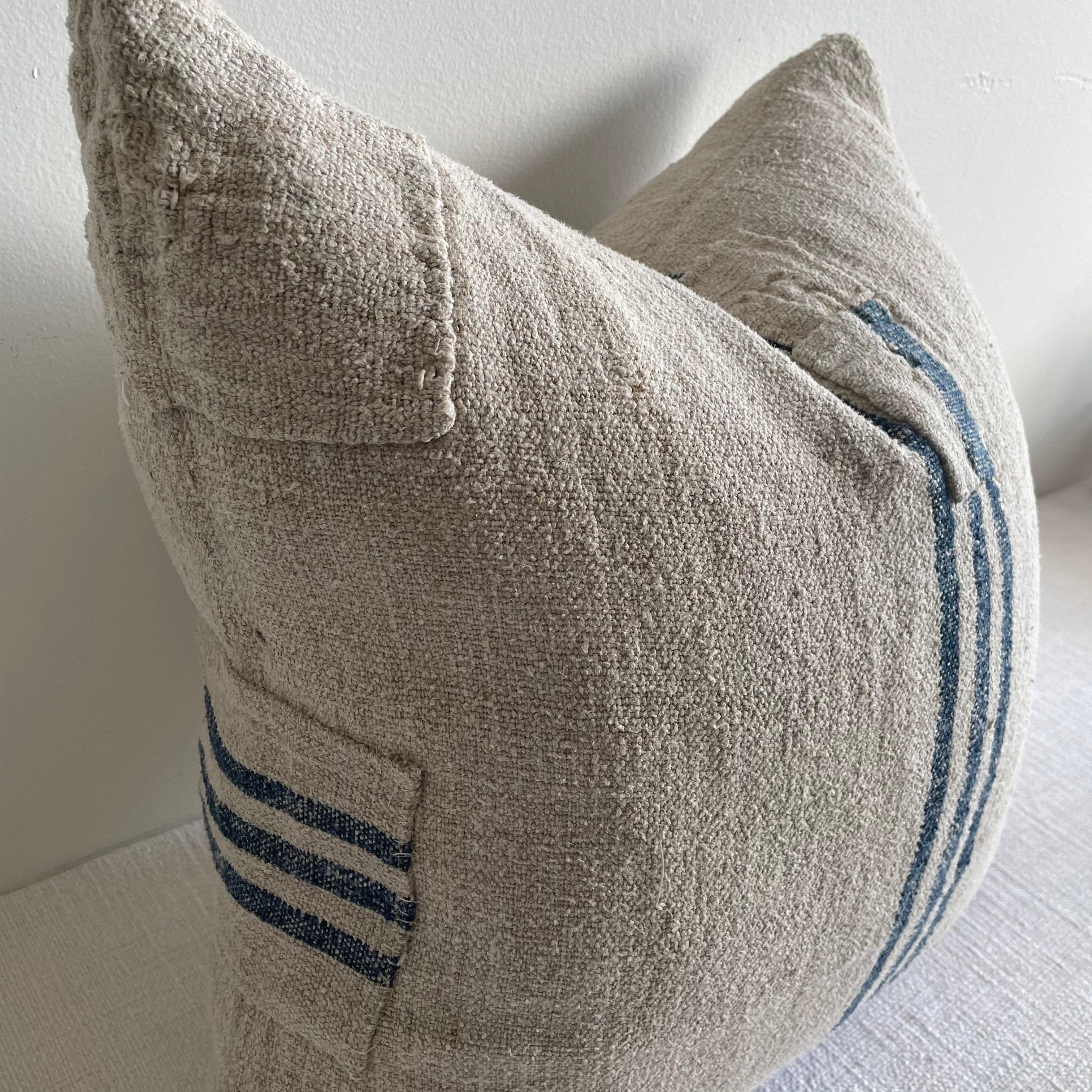 This vintage textile pillow is made from an antique European Grainsack with indigo stripe, natural nubby woven texture. Our pillows are constructed with vintage one of a kind textiles from around the globe. Carefully constructed with the finest