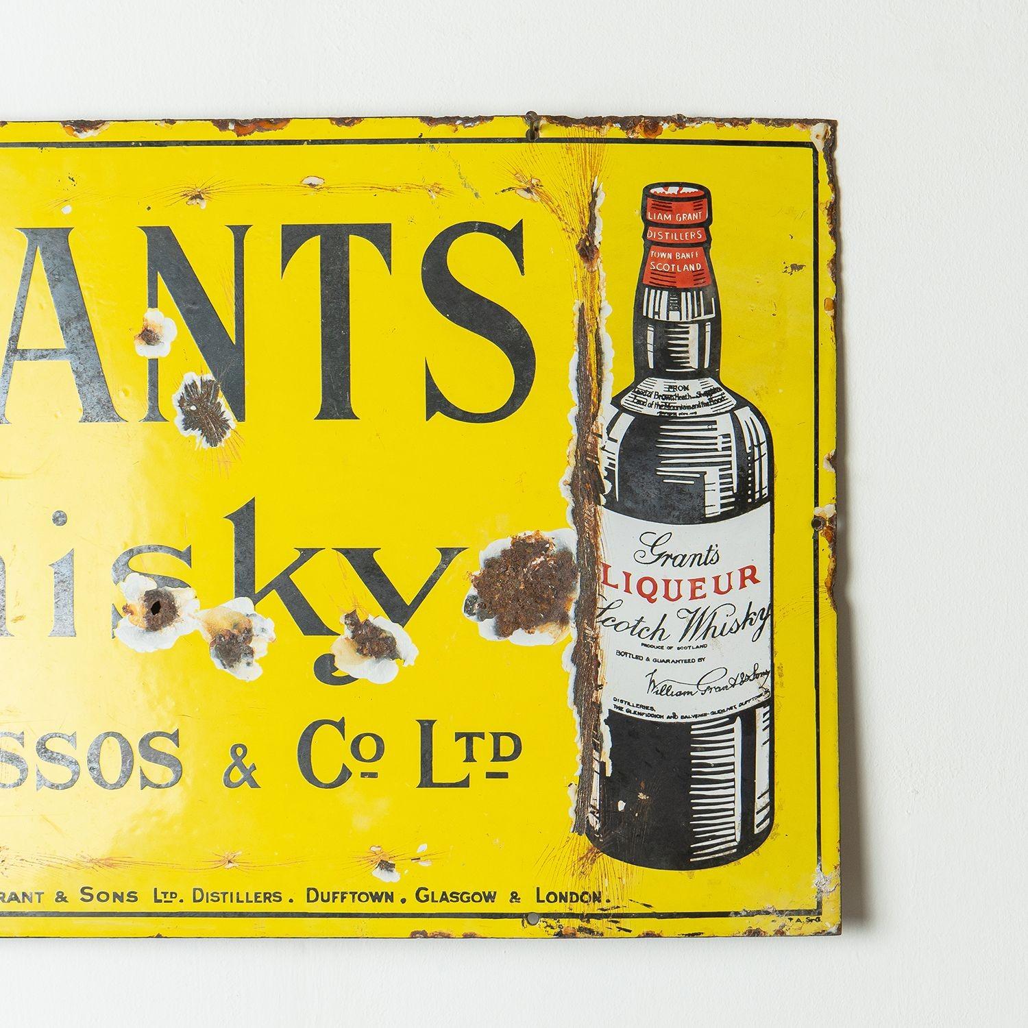 Antique Scottish Sign
Advertising ‘Grants Whisky, Agents Drossos & Co. Ltd. Proprietors William Grant & Son Ltd. Distilleries Dufftown, Glasgow and London.’
Alongside a pictorial image of a bottle of their blended Scotch whisky on a bright yellow