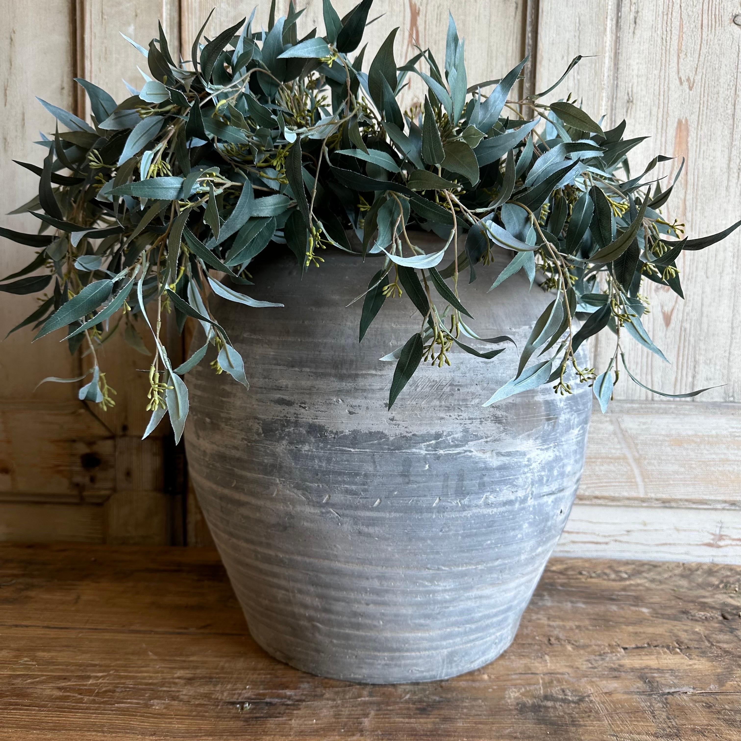 Vintage gray clay weathered pottery.
Beautiful weathered gray vintage clay pot that is beautifully colored and authentically worn. The surface of the pot and handle are peeling in places, revealing the original clay below. These qualities give the