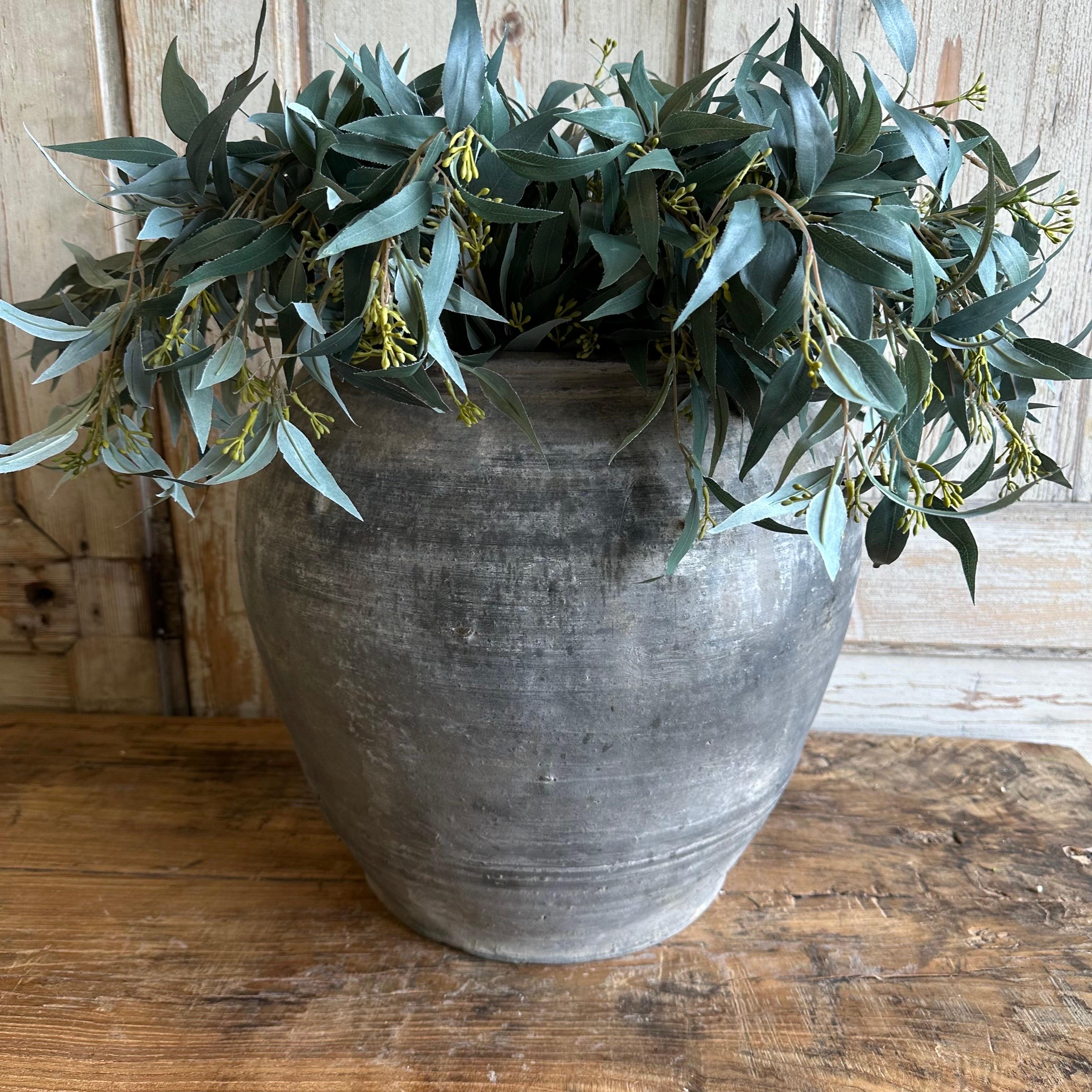 Beautiful weathered gray vintage clay pot that is beautifully colored and authentically worn. The surface of the pot and handle are peeling in places, revealing the original clay below. These qualities give the pot a lived-in appearance and will