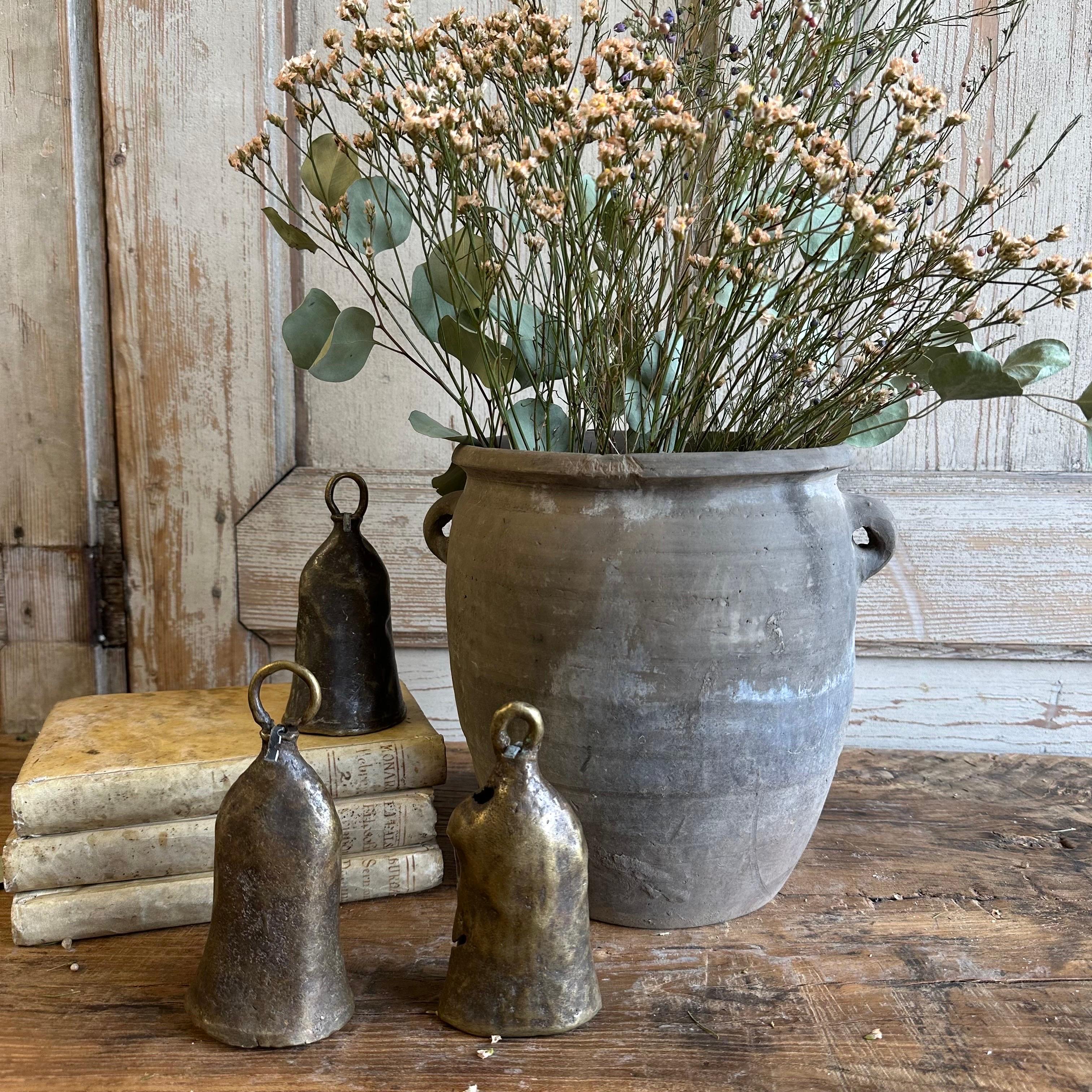 Beautiful weathered gray vintage clay pot that is beautifully colored and authentically worn. The surface of the pot and handle are peeling in places, revealing the original clay below. These qualities give the pot a lived-in appearance and will