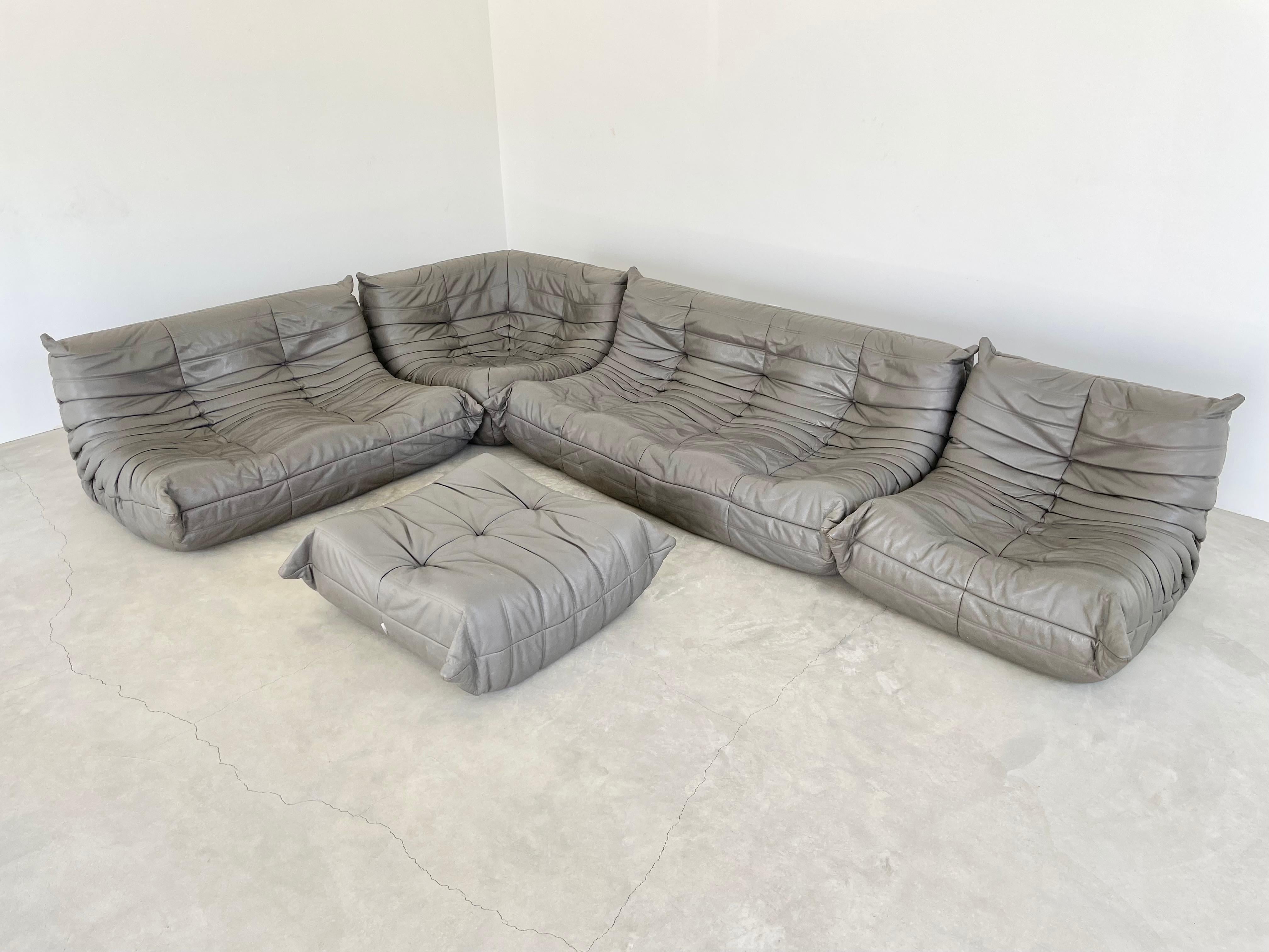 Classic French Togo set by Michel Ducaroy for luxury brand Ligne Roset. Originally designed in the 1970s the iconic togo sofa is now a design classic. This set comes in its original vintage gray leather.

Timeless comfort and style make this