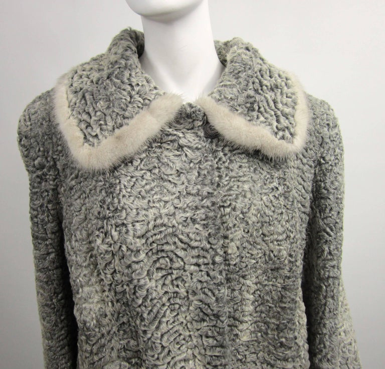 Stunning vintage 1960s Persian Car Coat. Gray Persian Lamb with Mink Accents on collar and cuffs. Large Deep Pockets. This is a bigger jacket and will fit a size 12-14 nicely. Button at the collar and 2 Hook and eye closures that can be moved to