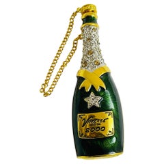 GRAZIANO, broche bouteille de champagne vintage signée, de couleur or avec strass