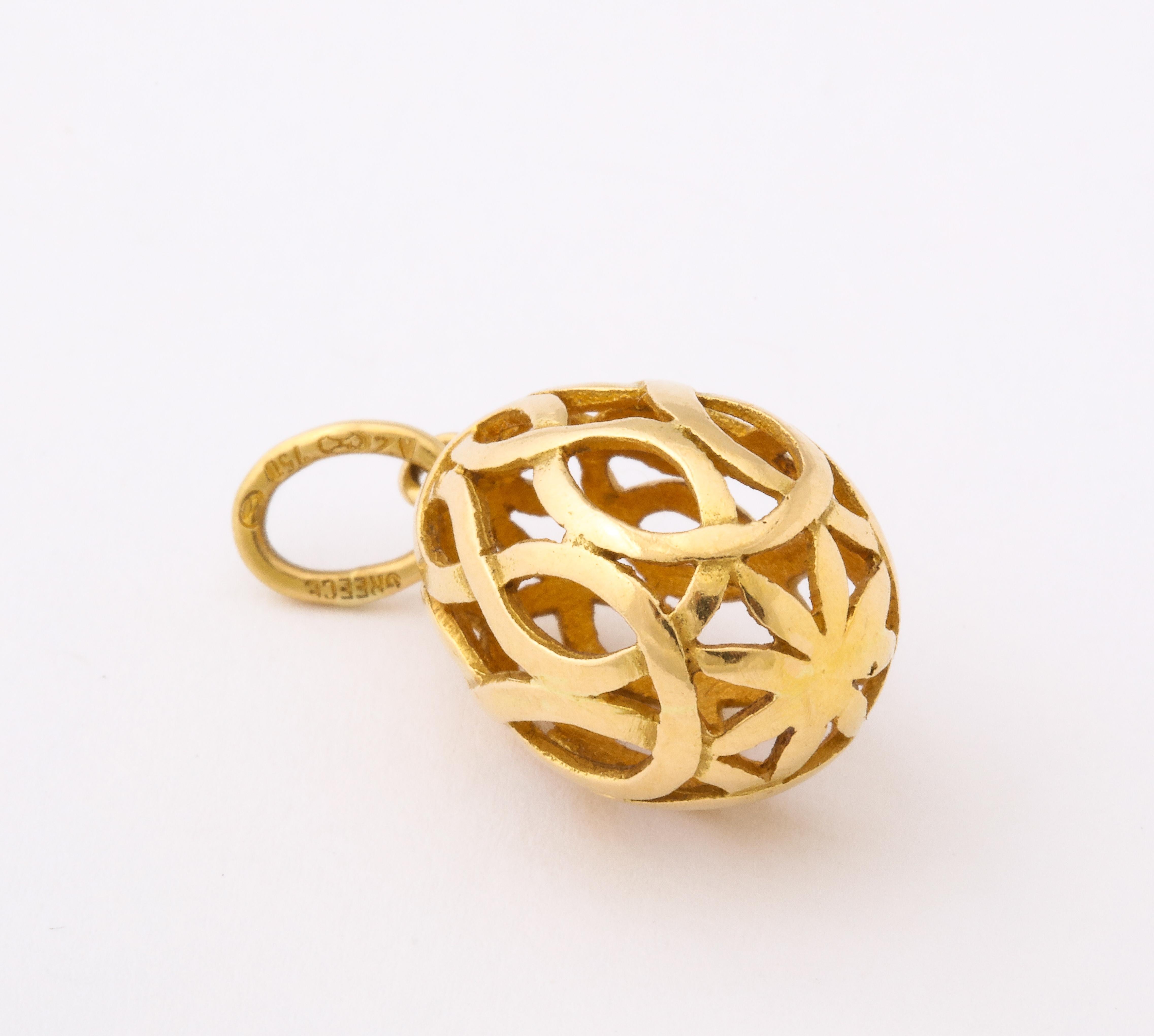 An egg pendant of 18 kt gold made in Greece in an open lattice work design. Egg jewelry has many possibilities of personal meaning to different people. In Greek tradition, the egg was a symbol of resurrection, rebirth and renewal. The intertwining
