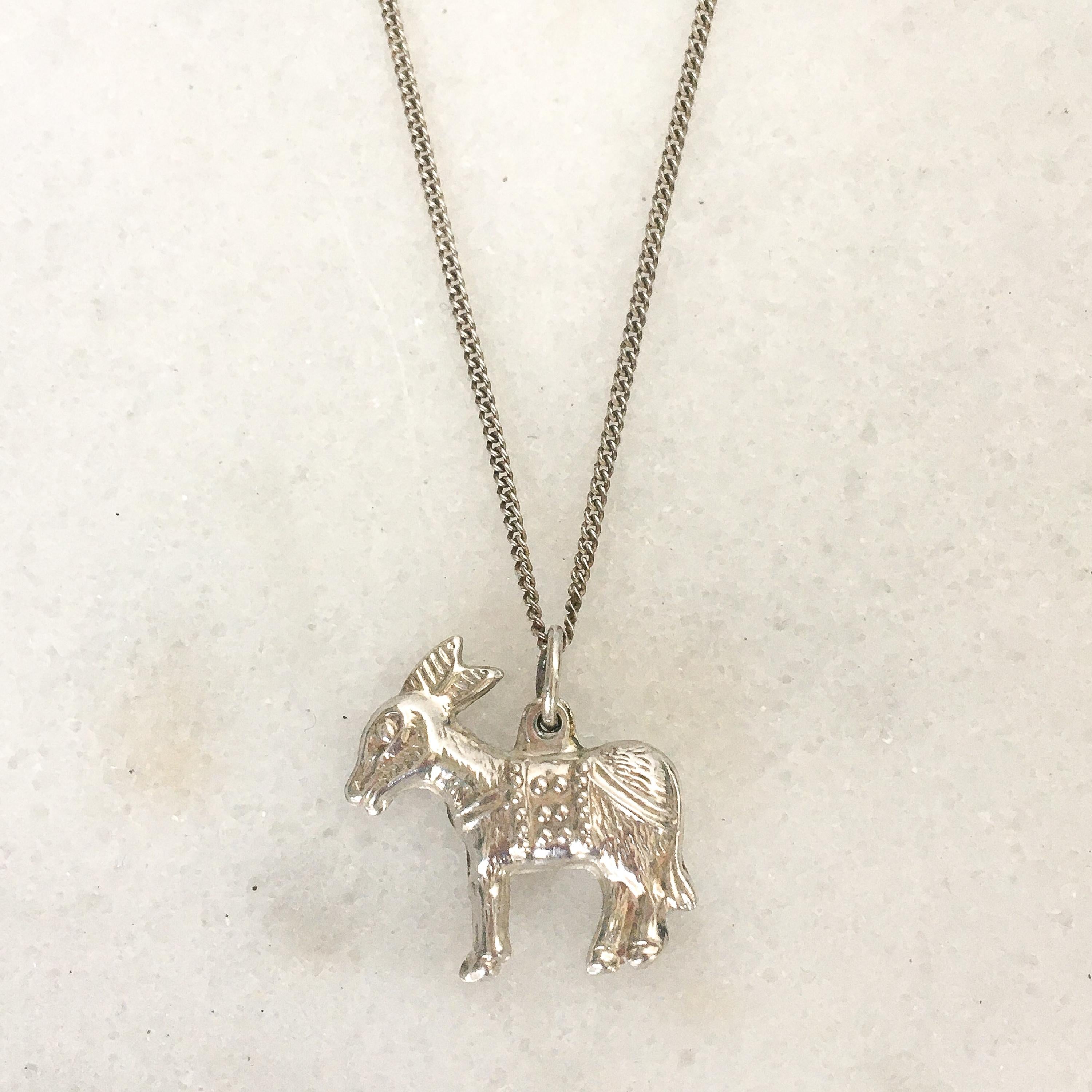 Like the Greek work mule, donkeys were portrayed in Biblical works as symbols of service, suffering, peace and humility. This sweet vintage donkey charm is made of silver. It's a lovely charm to add to your charm bracelet, wear as a necklace,