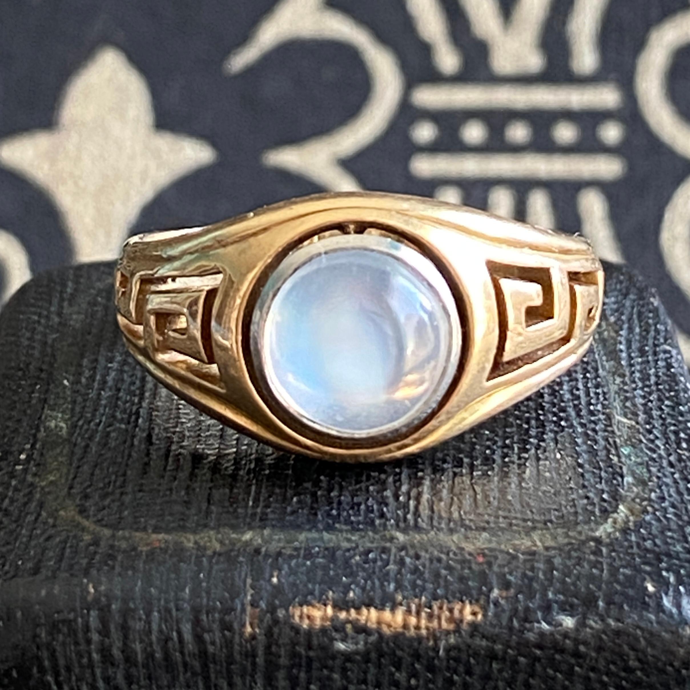 Details:
Awesome vintage greek moonstone ring. Both shoulders have pierced greek key work. Around the center is also pierced half circles. This surrounds a stunning moonstone! There is so much life and glow to this stone. A fine A grade example.