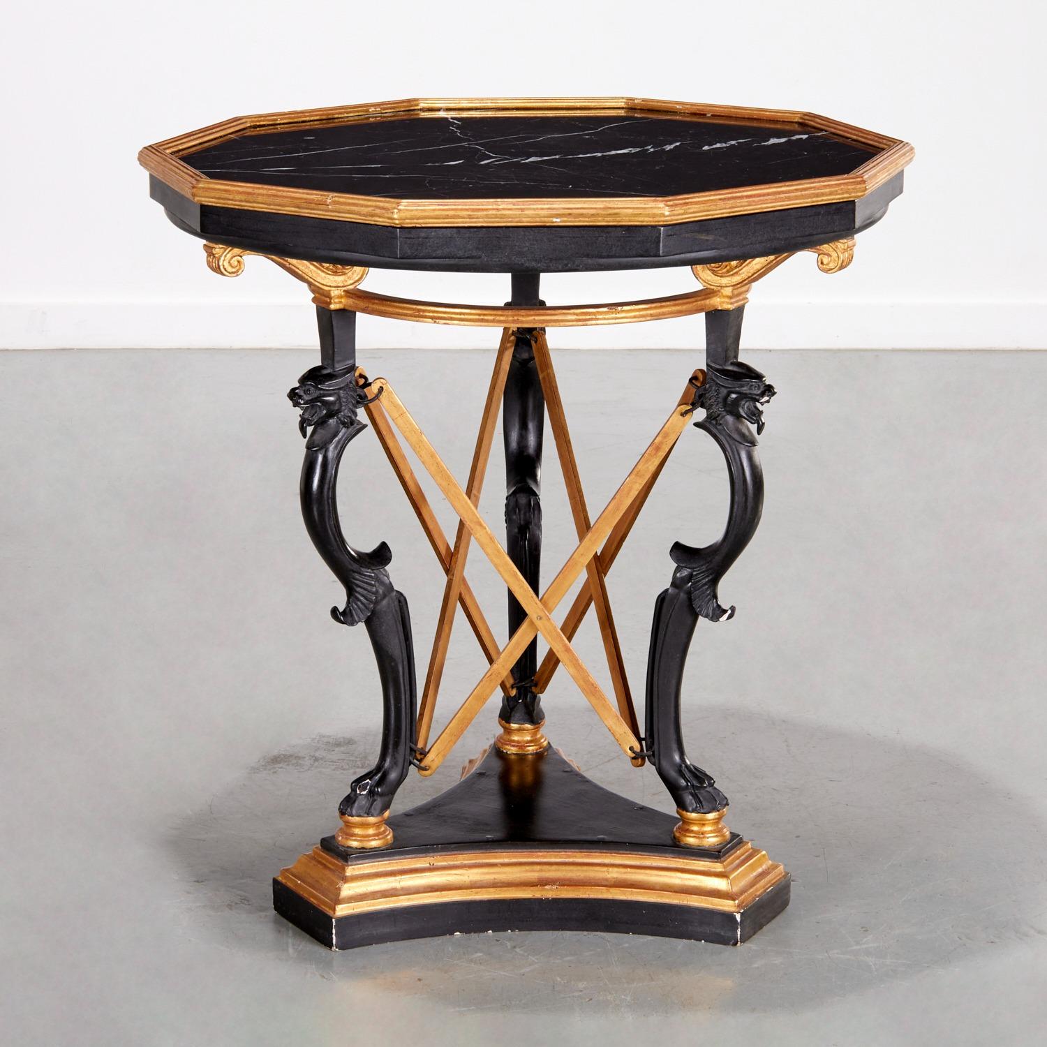 Vintage (mid-century) center or large side table in the Greek style, finely crafted with ebonized and partially gilt wooden frame and octagonal shaped black marble top, supported by carved legs topped with lion heads and terminating with paw feet on