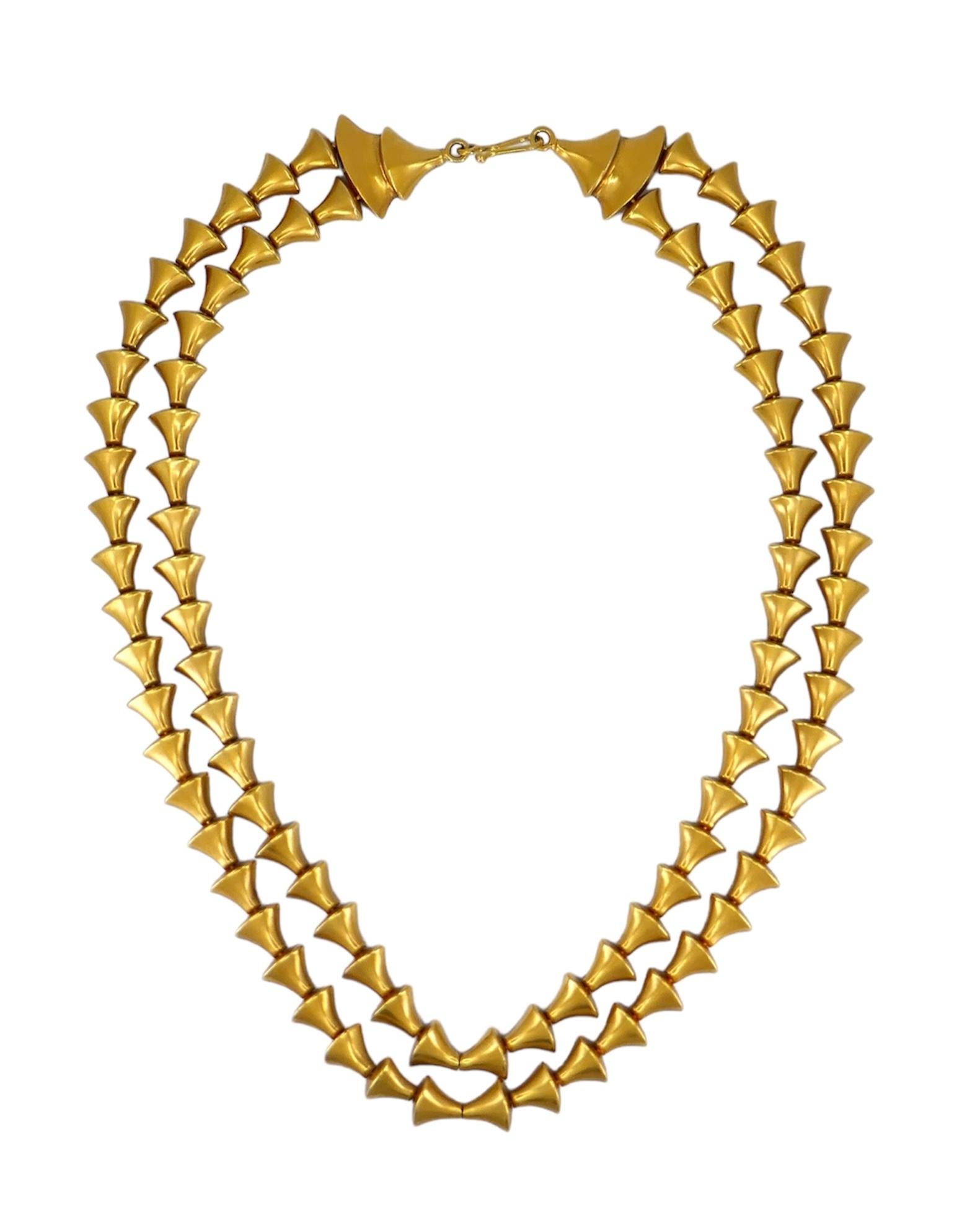 Crafted by Greek design house Zolotas in the 1970s, this 18k gold necklace epitomizes timeless elegance and craftsmanship. It features a double-stranded design with a fish hook closure. Weighing 72.1 grams, the the inner chain measures 16.5 inches,