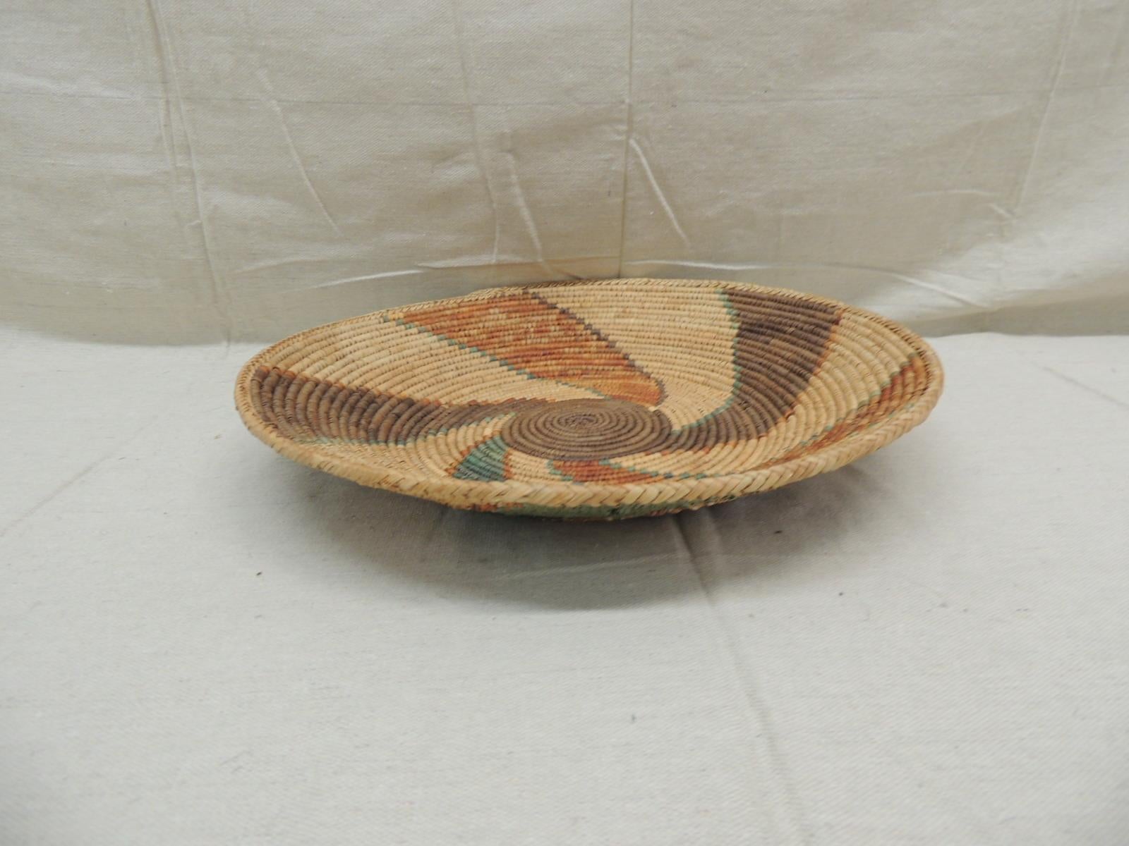 Vintage green and brown coiled decorative round basket
Woven decorative basket with swirl pattern in shades of brown, tan, green, orange and taupe.
Size: 14