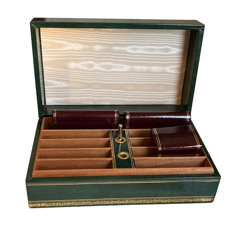 A handsome rectangular green leather Abercrombie & Fitch bridge card box. This box is gorgeous bound in a malachite look green leather with a gold stamped design around the edges and corners. On the top, it is stamped in gold with the first owner's