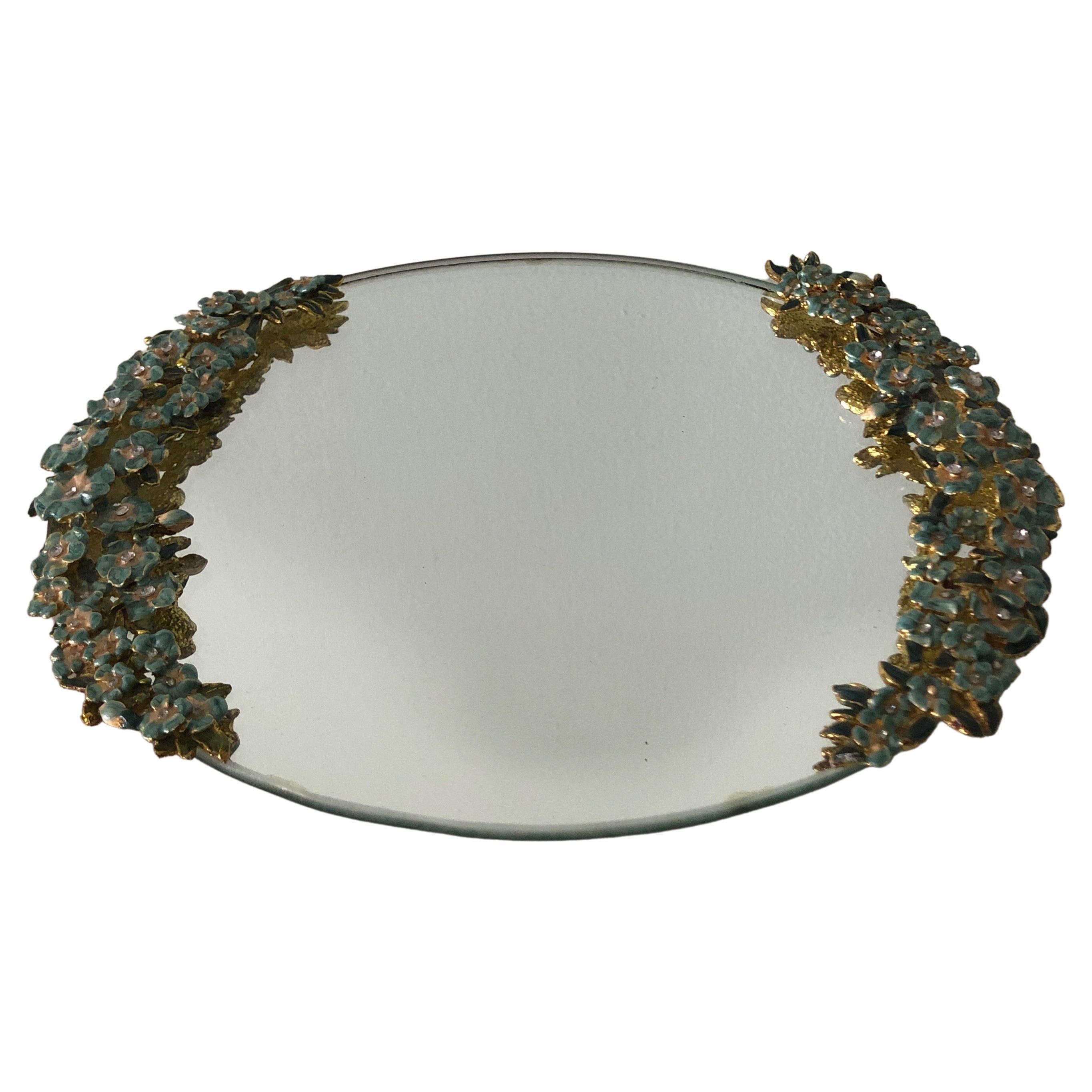 Vintage green and gold oval vanity tray with enamel flowers handles and inset mirror.
Size: 9.5