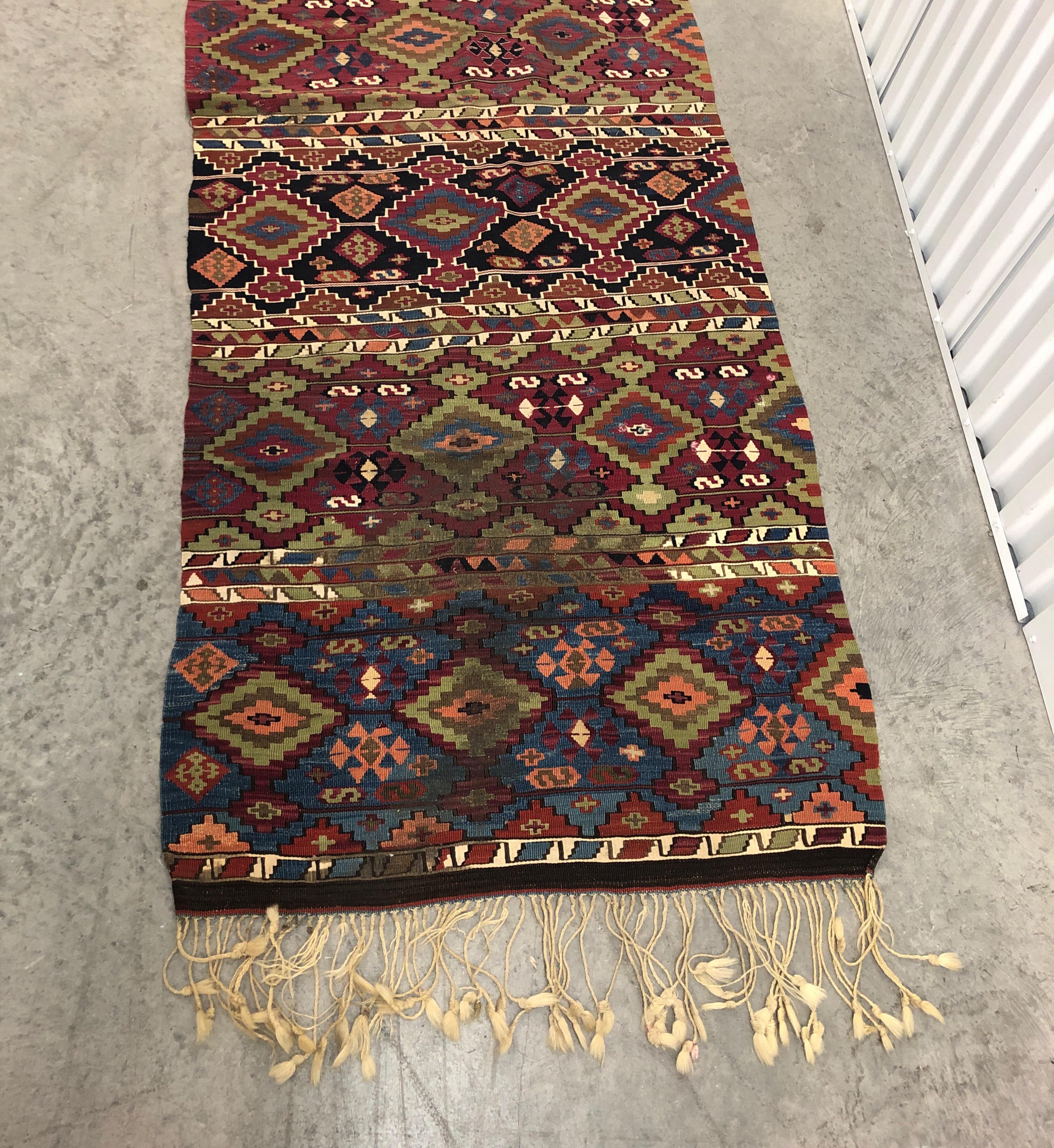 Vintage green and orange long Kilim runner with hand knotted fringes.
Long rug with multi color field.
Size: 143”L x 33” W 
(including fringes that are 6” long).