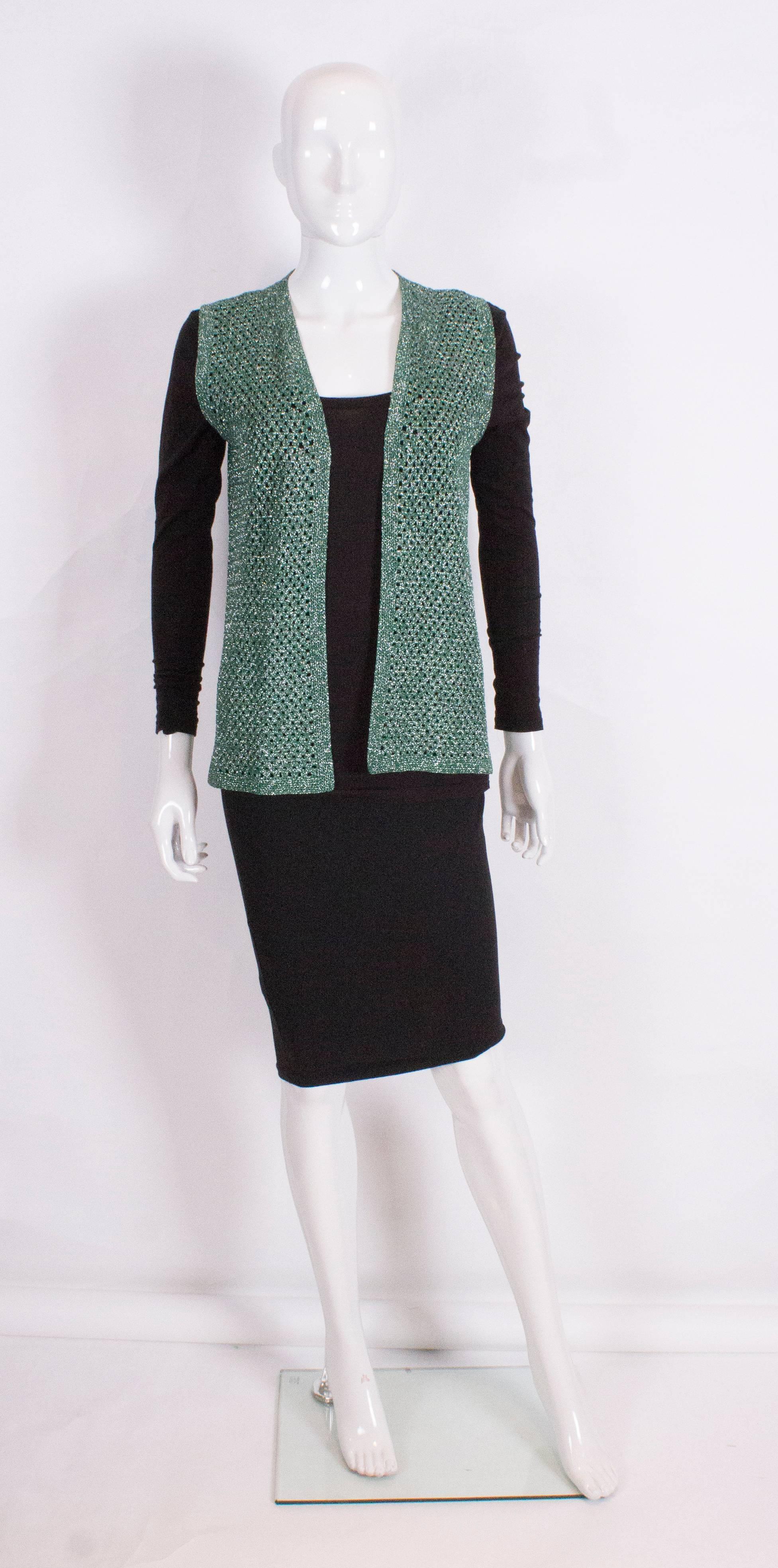 An easy to wear vintage silver and green sleevless crochet gilet. Ideal for brightening up Fall and Winter wear.
