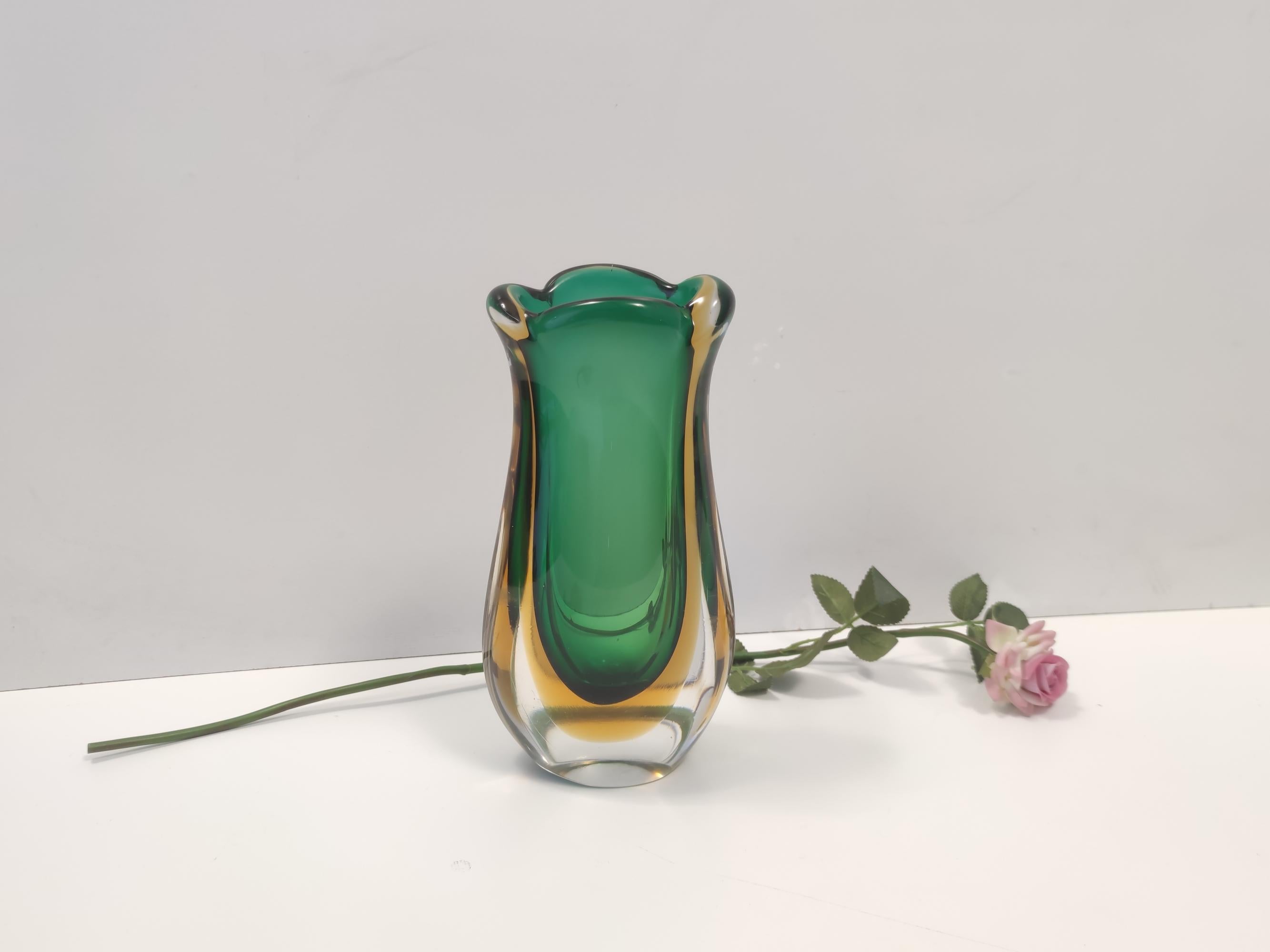 Made in Italy, 1950s - 1960s. 
This vase is made in Sommerso Murano glass, which has been hand blown with three different colors: transparent, yellow and green.
It is a vintage item, therefore it might show slight traces of use, but it can be