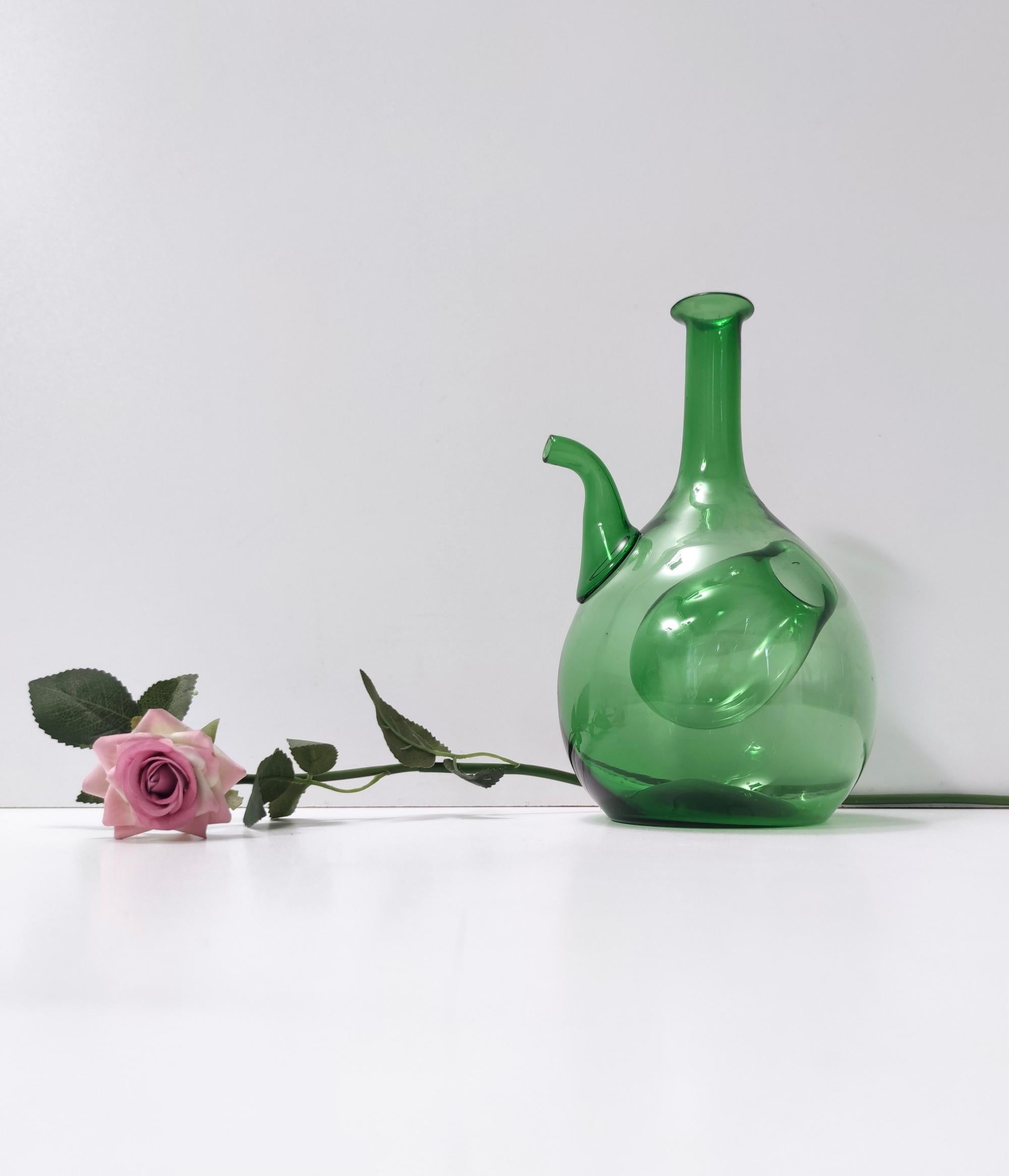 Made in Empoli, Italy, 1940s - 1950s.
This stunning jug is made in green blown glass and features an internal 
