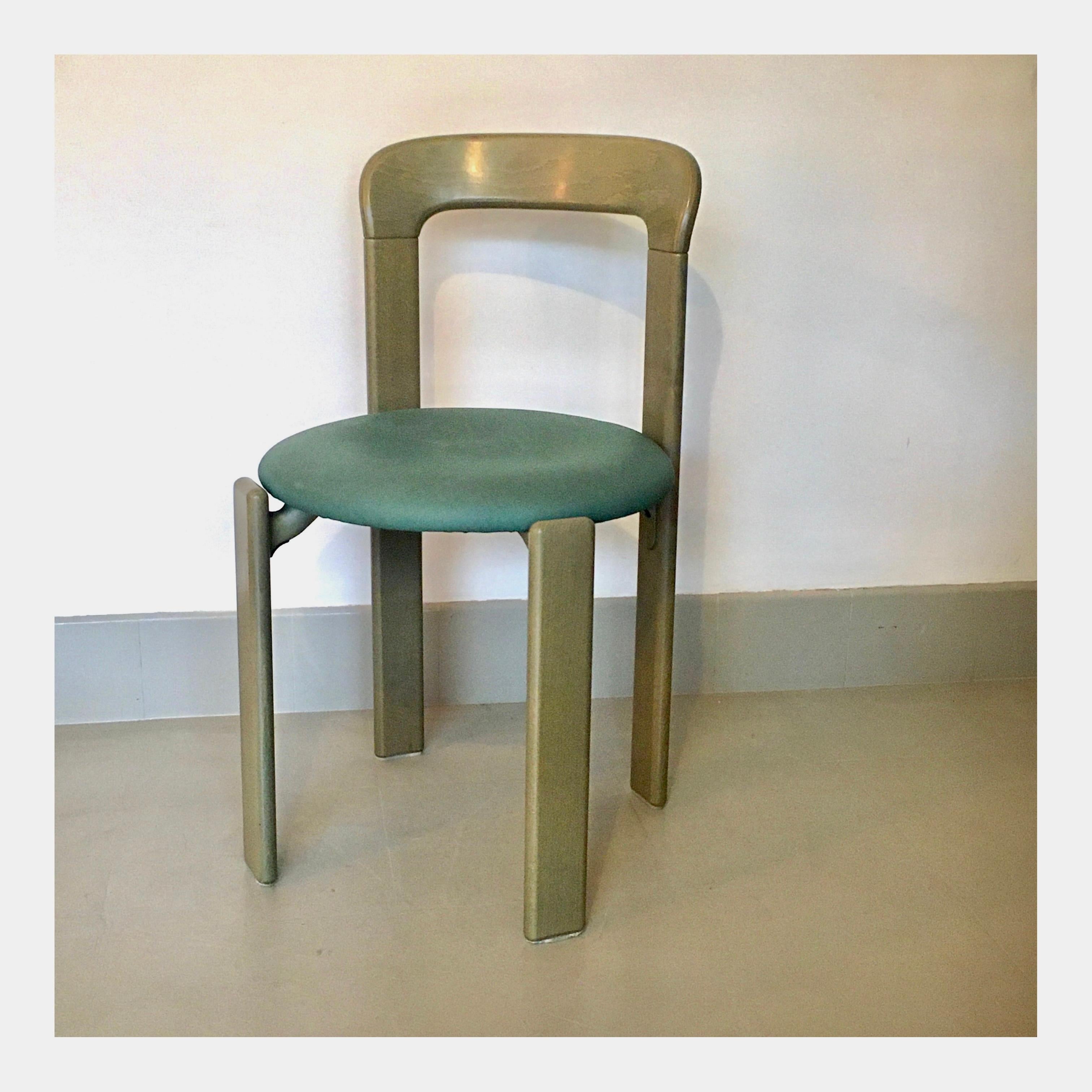 Designed by Bruno Rey for Dietiker in the 70s, Switzerland. Several pieces available. The version offered here is in stained wood in a deep olive green. Seats are covered with a green lavable skai fabric. The chairs are solid, robust and above all