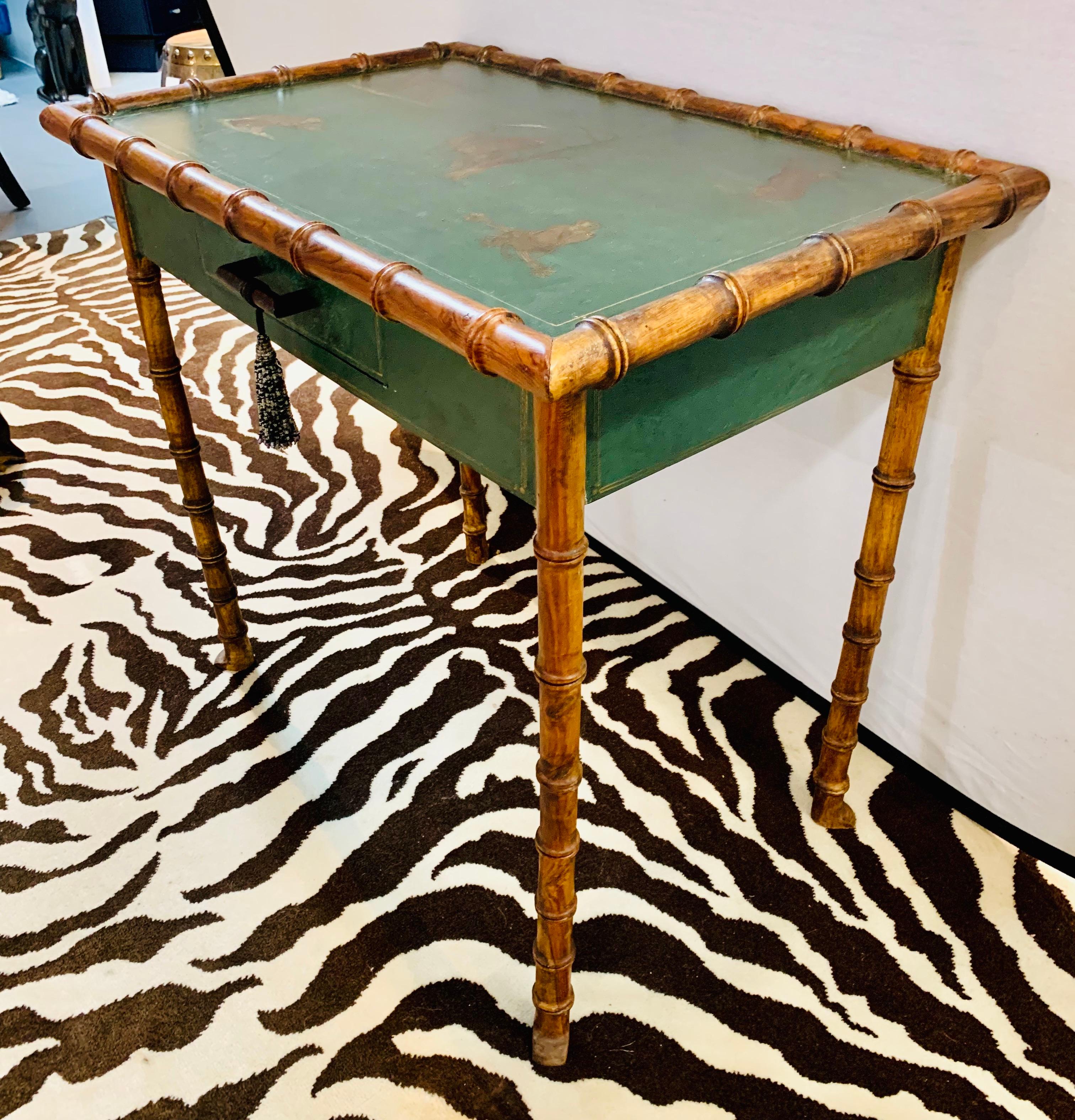 A vintage green chinoiserie style one drawer writing desk with painted monkeys on top. Legs have been carved to mimic bamboo.