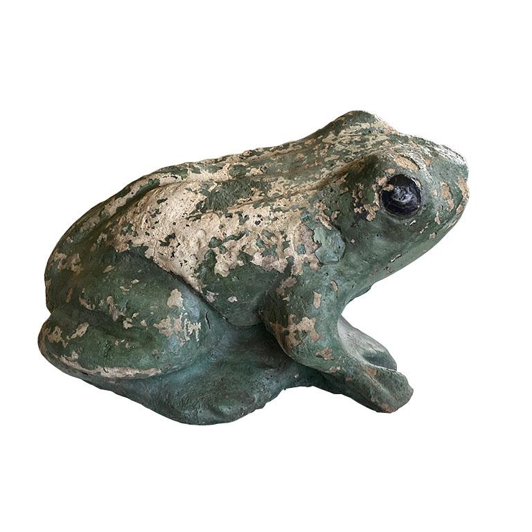 A wonderful addition to your patio or garden, this small concrete frog will bring a touch of vintage to any space. Created from concrete, it has been painted green with black eyes. 

Dimensions:
13