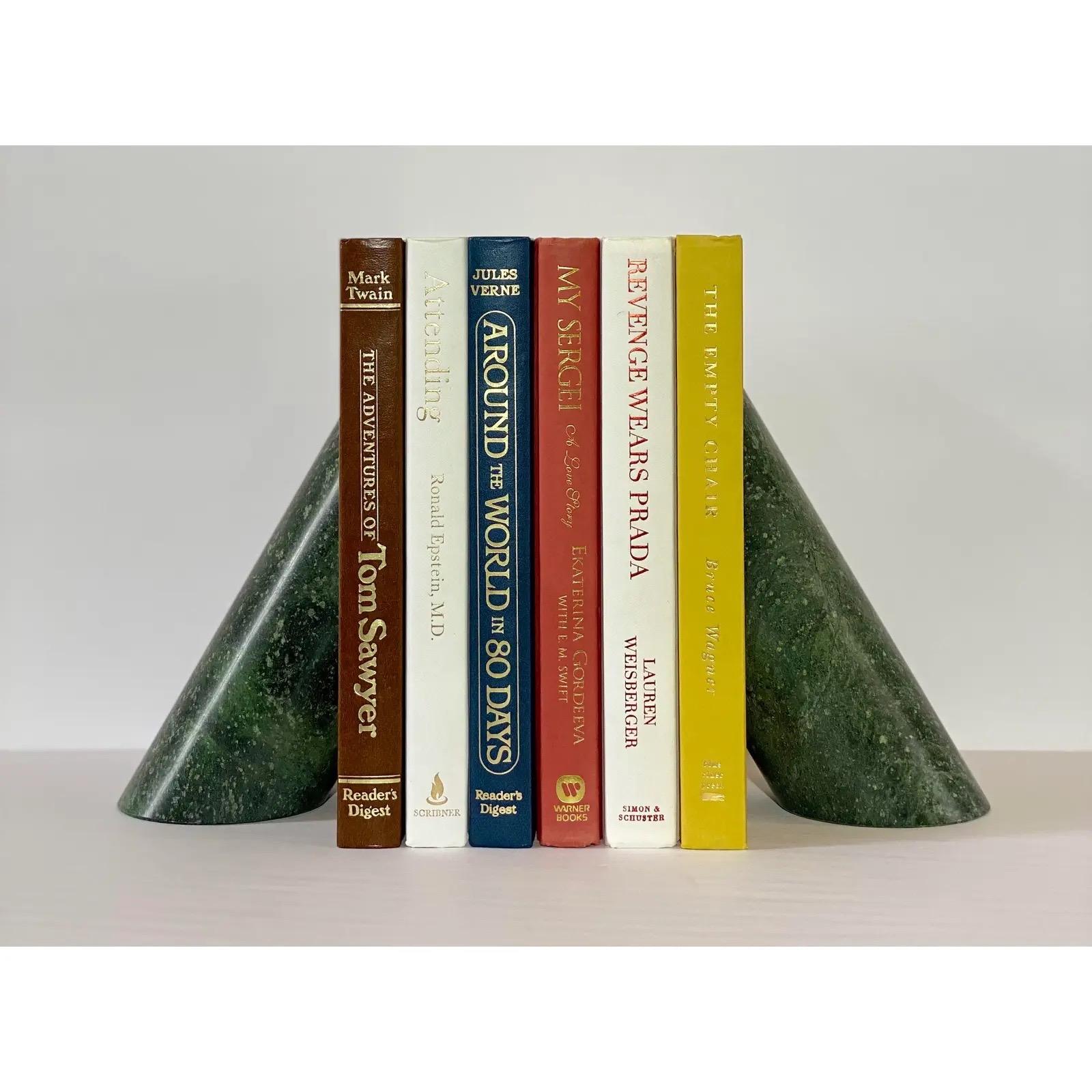 We are very pleased to offer a sculptural and functional pair of bookends, circa the 1970s. Constructed of dark green marble, the cylindrical shape features a diagonal cut on top and a smooth, polished surface. In excellent condition. Please see all