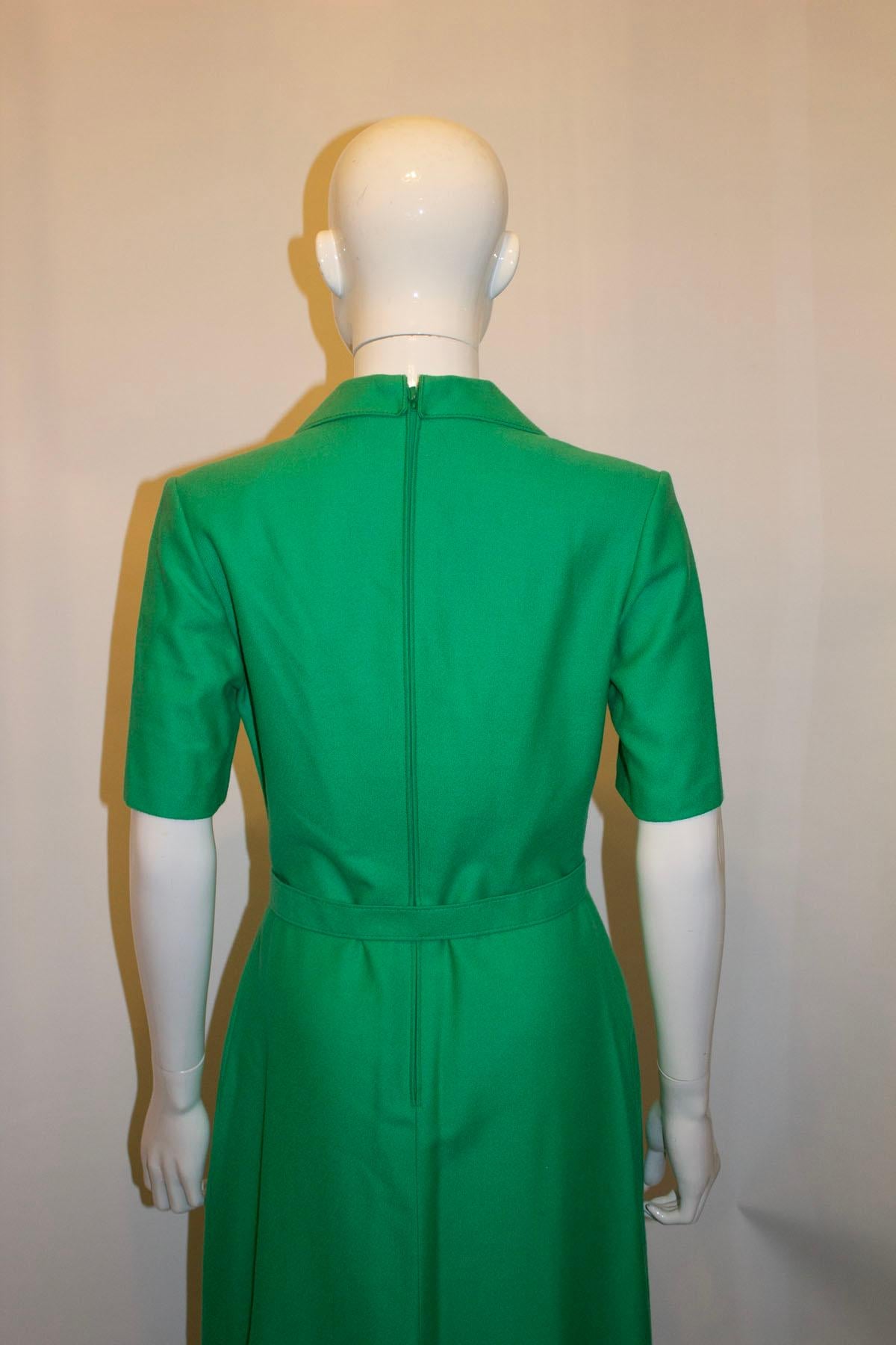 A chic and easy to wear vintage dress by BaoBod ,styled by Fritschen. The dress is in a green wool,  and fully lined. It has pleats on the front , a back central zip, short sleaves and a self fabric belt.  Size 38
Measurements: Bust 36'', waist