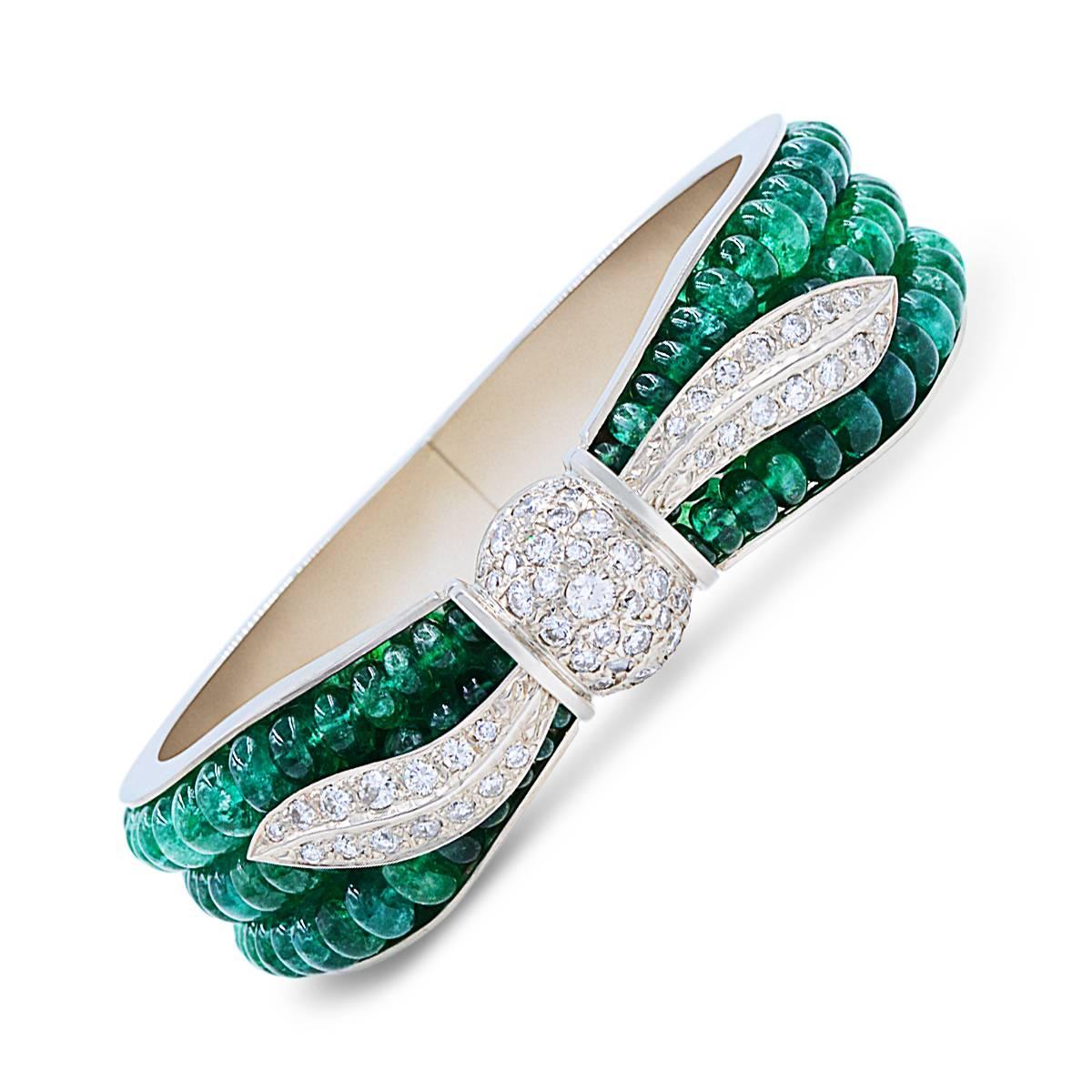 Overlapping green button shape emeralds from Colombian mines of Muzo with this bright and cheerful Victorian-era look we are sure this bangle bracelet will make a stunning gift. Crafted in 14k white gold we are excited for you to have it or purchase