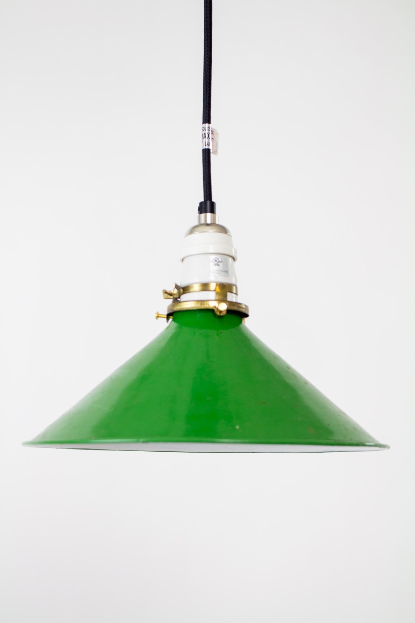 Vintage green enamel industrial pendant. Black cord and canopy, porcelain antique style socket, antique clamp fitter and green enamel conical shade. Shown with Edison style bulb as a style suggestion, bulb is not included. Fixture is adjustable from
