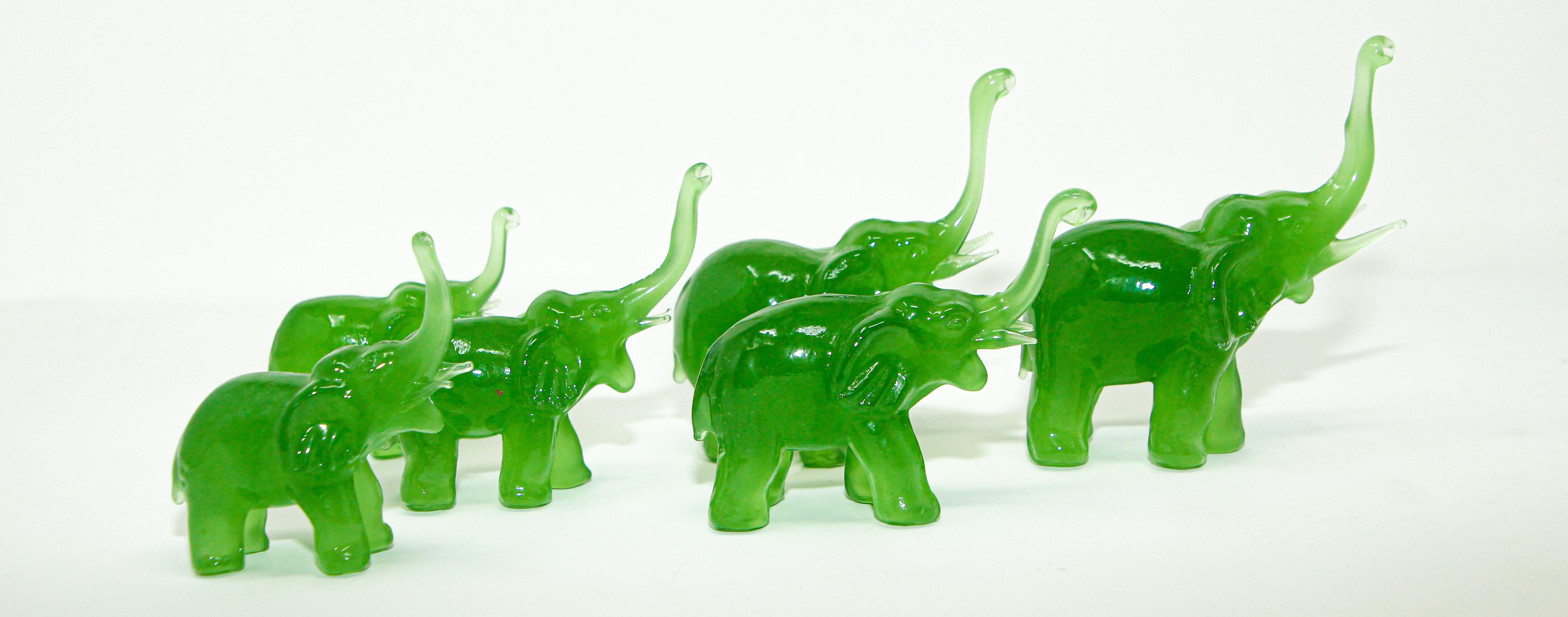 Vintage handcrafted jade green color glass elephants group sculptures.
Vintage elephant figurine made from translucent, mint green, Peking glass in green emerald jade color.
Collectible Asian vintage sculpture set of 6 elephants family figurines