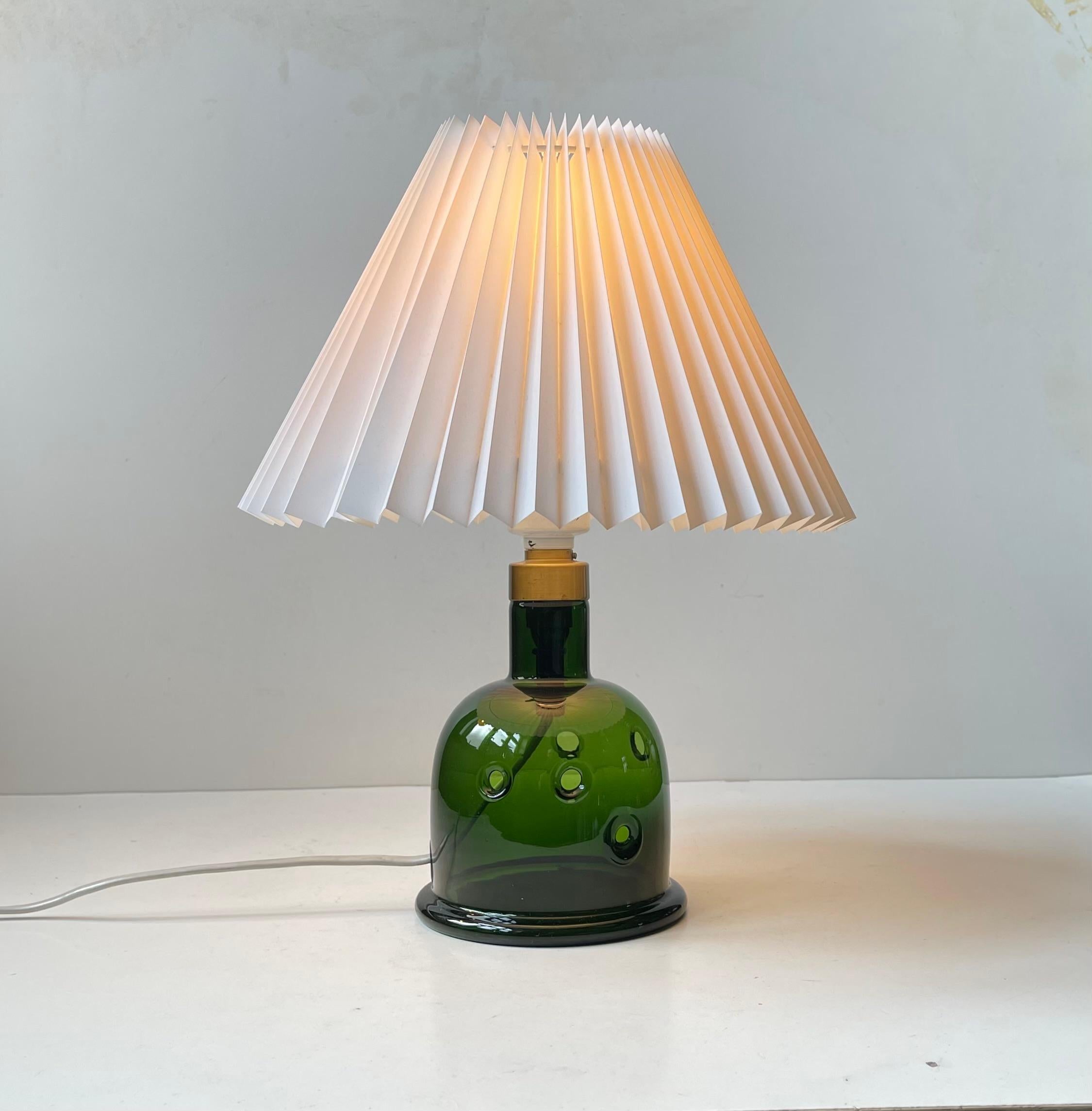 Handblown deep green Glass Table Lamp designed by Michael Bang and manufactured by Holmegaard in Denmark during the late 1970. It is called Meteor D (large model). Label from Holmegaard still present beneath the base. Height with shade 35 cm. It