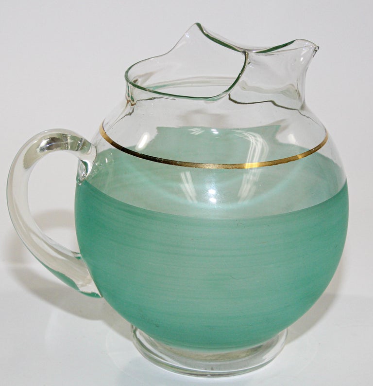 https://a.1stdibscdn.com/vintage-green-glass-pitcher-american-collectible-1960s-for-sale-picture-2/f_9068/f_255977721633443558552/Vintage_MCM_Green_Glass_Pitcher_American_collectible_2_master.jpg?width=768