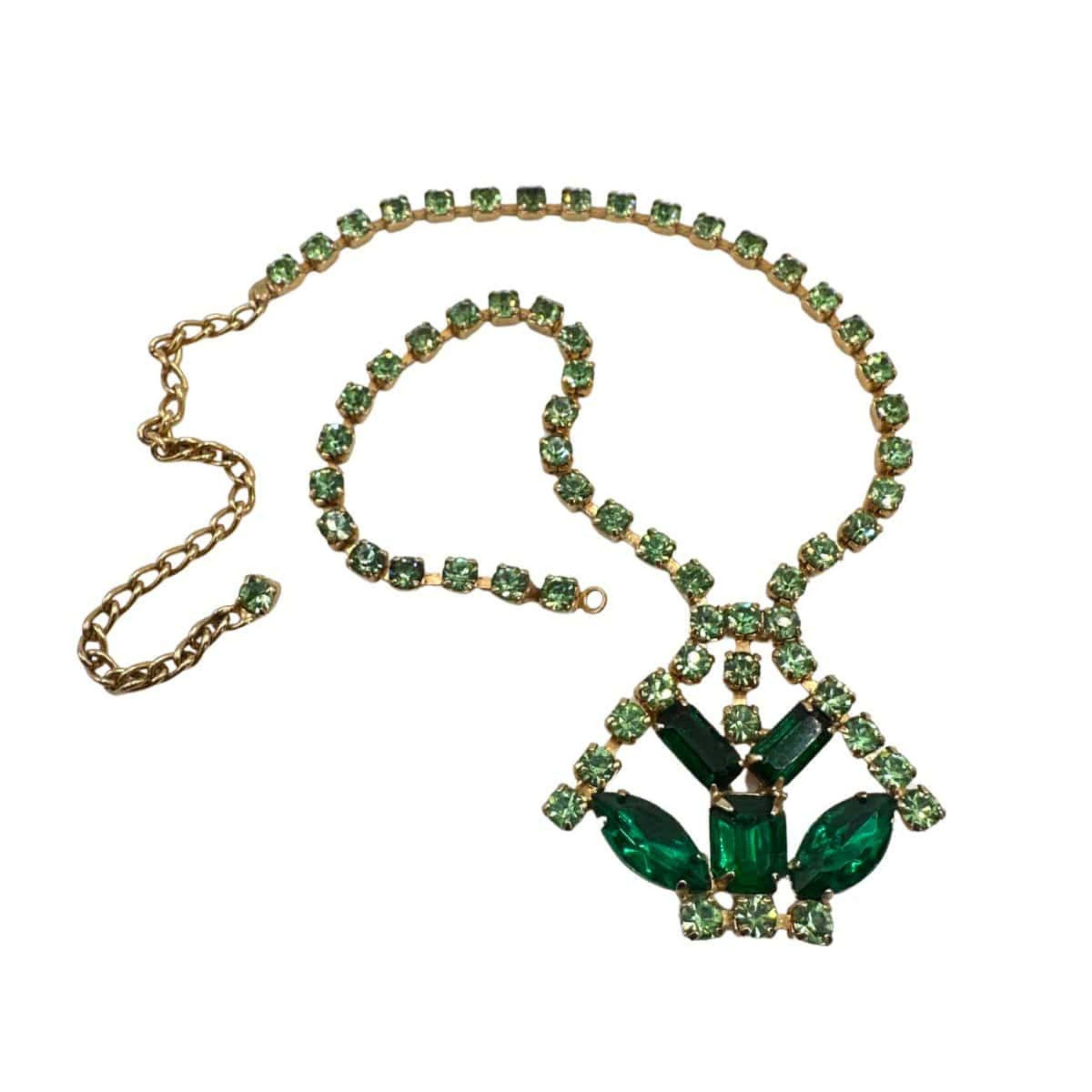 A Timeless Duo of Vintage Elegance
This exquisite vintage jewelry set blends the brilliance of green glass stones with the sparkle of rhinestones, creating a truly captivating ensemble. Featuring both a 15-inch necklace and a 7-inch bracelet, this