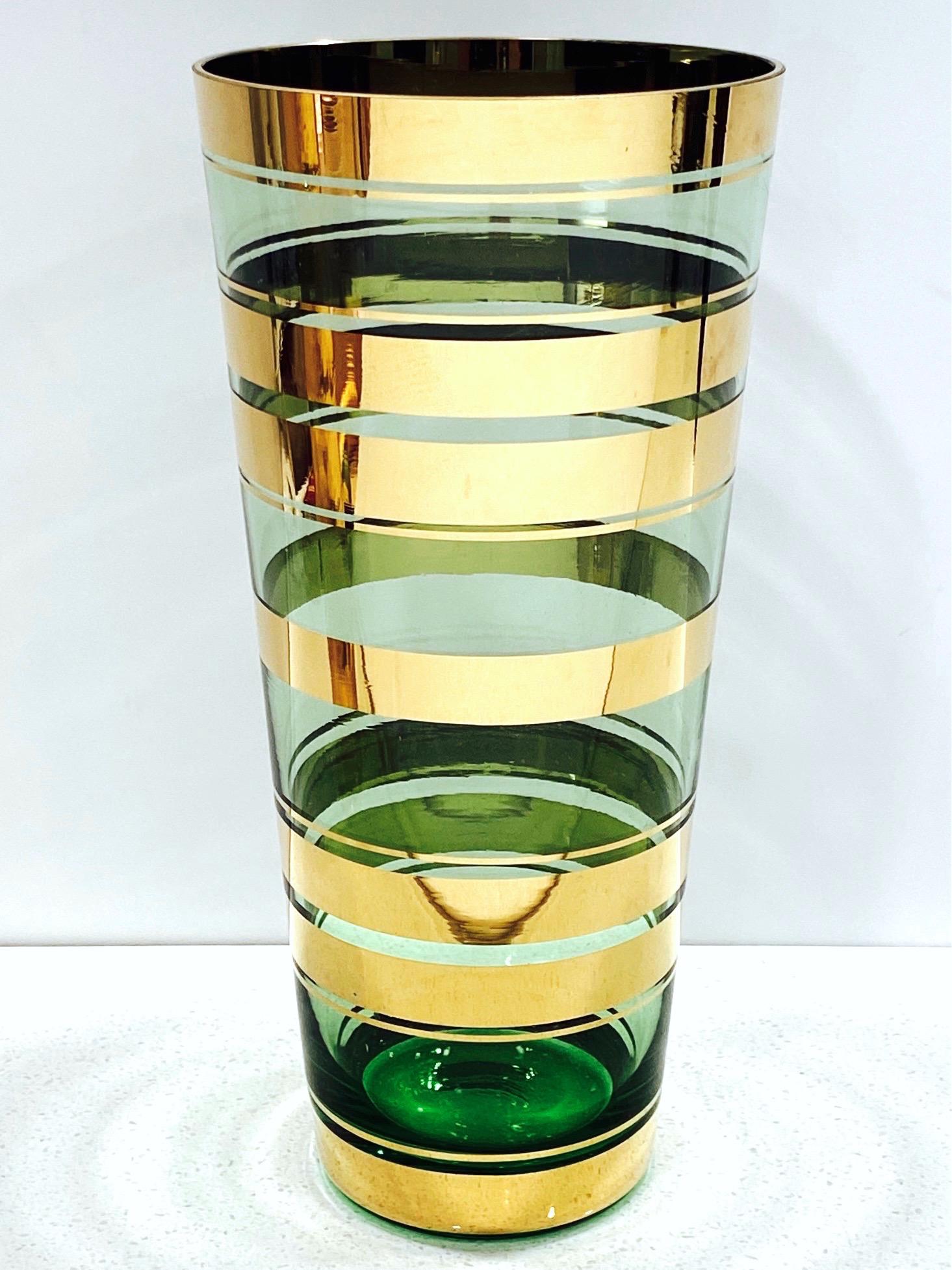 Mid-Century Modern handblown art glass vase with tapered form from the Czech Republic. Features beautiful translucent green glass with 24-karat gold overlays throughout. Functional vase or as decorative item.
