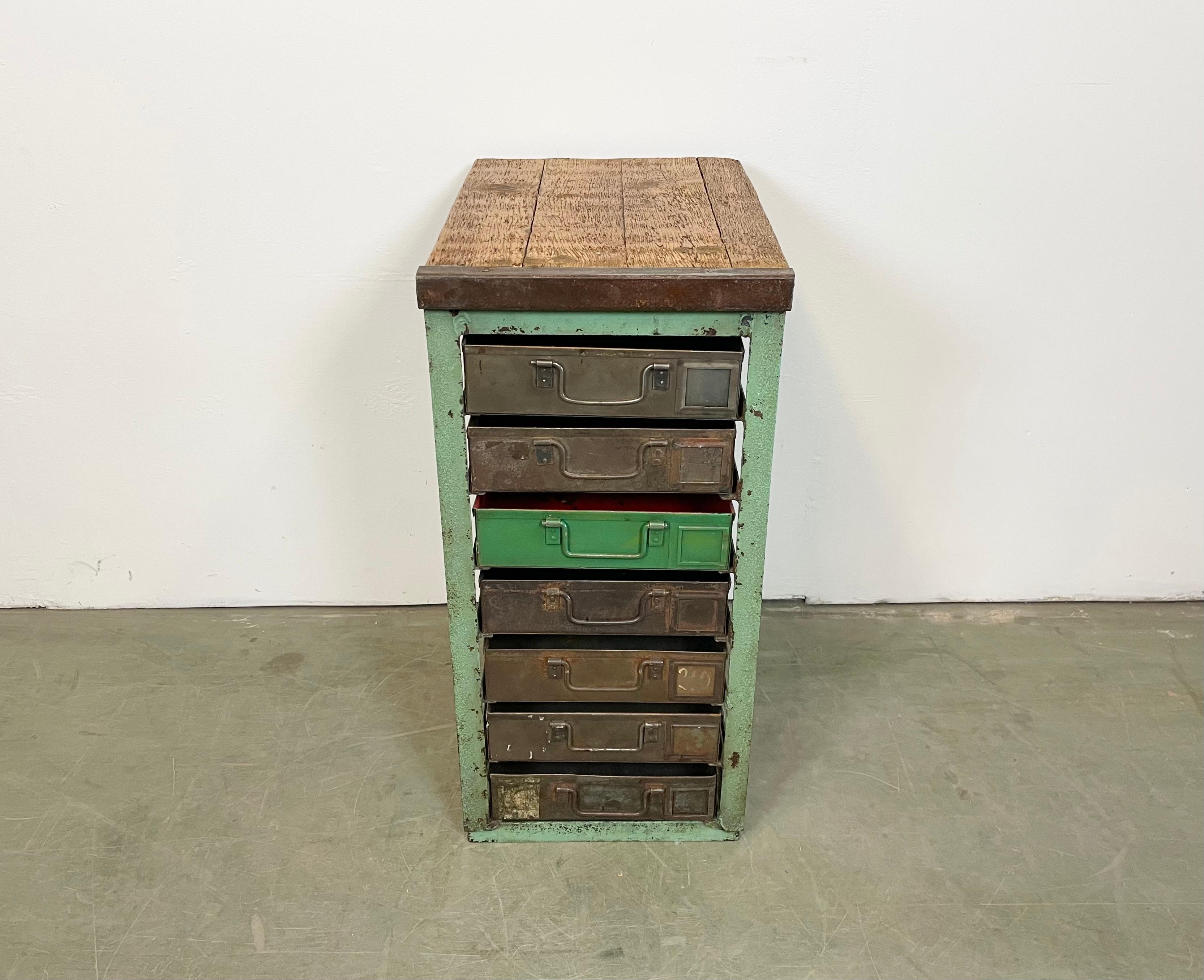 This vintage Industrial iron chest of drawers was made during the 1950s. It features an iron construction, old wooden top and 7 metal drawers. Additional dimensions: 
Drawer dimensions :- Width 28 cm, depth 44 cm, height 8 cm 
- Weight: 37 kg.