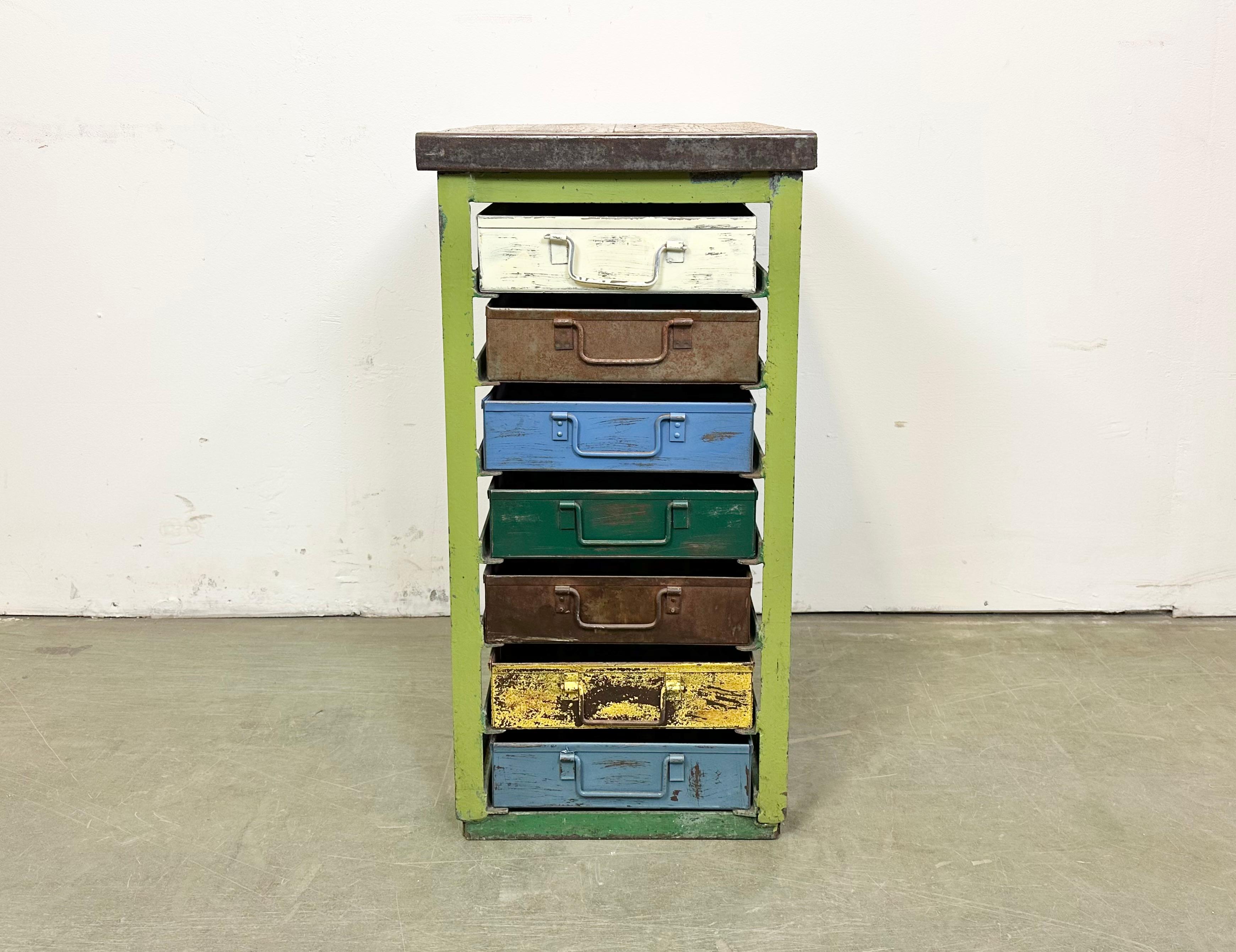 This vintage Industrial iron chest of drawers was made in former Czechoslovakia during the 1950s. It features an iron construction, a solid wooden top and 7 metal drawers. Additional dimensions: 
Drawer dimensions :- Width 28 cm, depth 44 cm, height