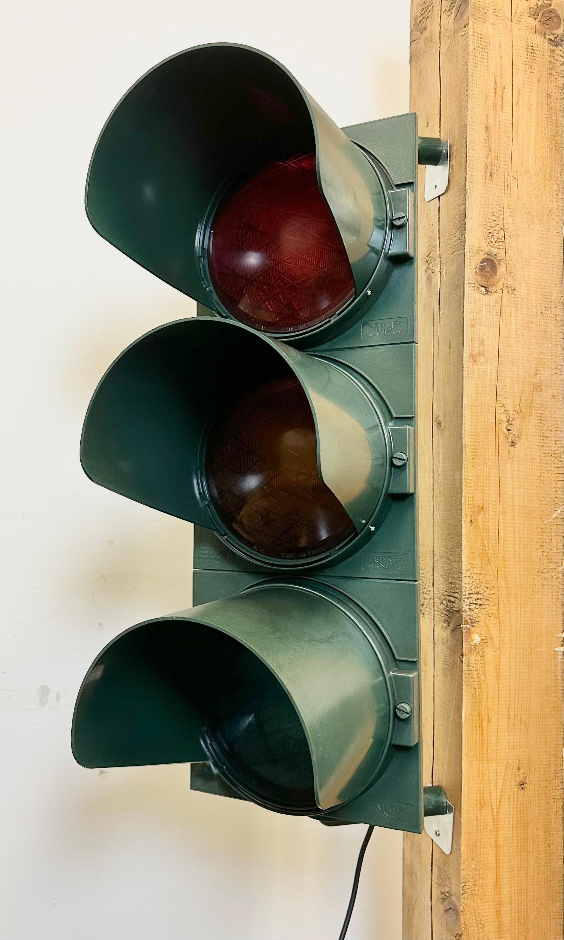 Vintage industrial italian traffic lights made by SCAE Milano in Italy during the 1980s. It features green bakelite body and color plastic glass covers. The sockets require standard E 27/ E 26 lightbulbs. Rewired to be lit as a lamp or decorative