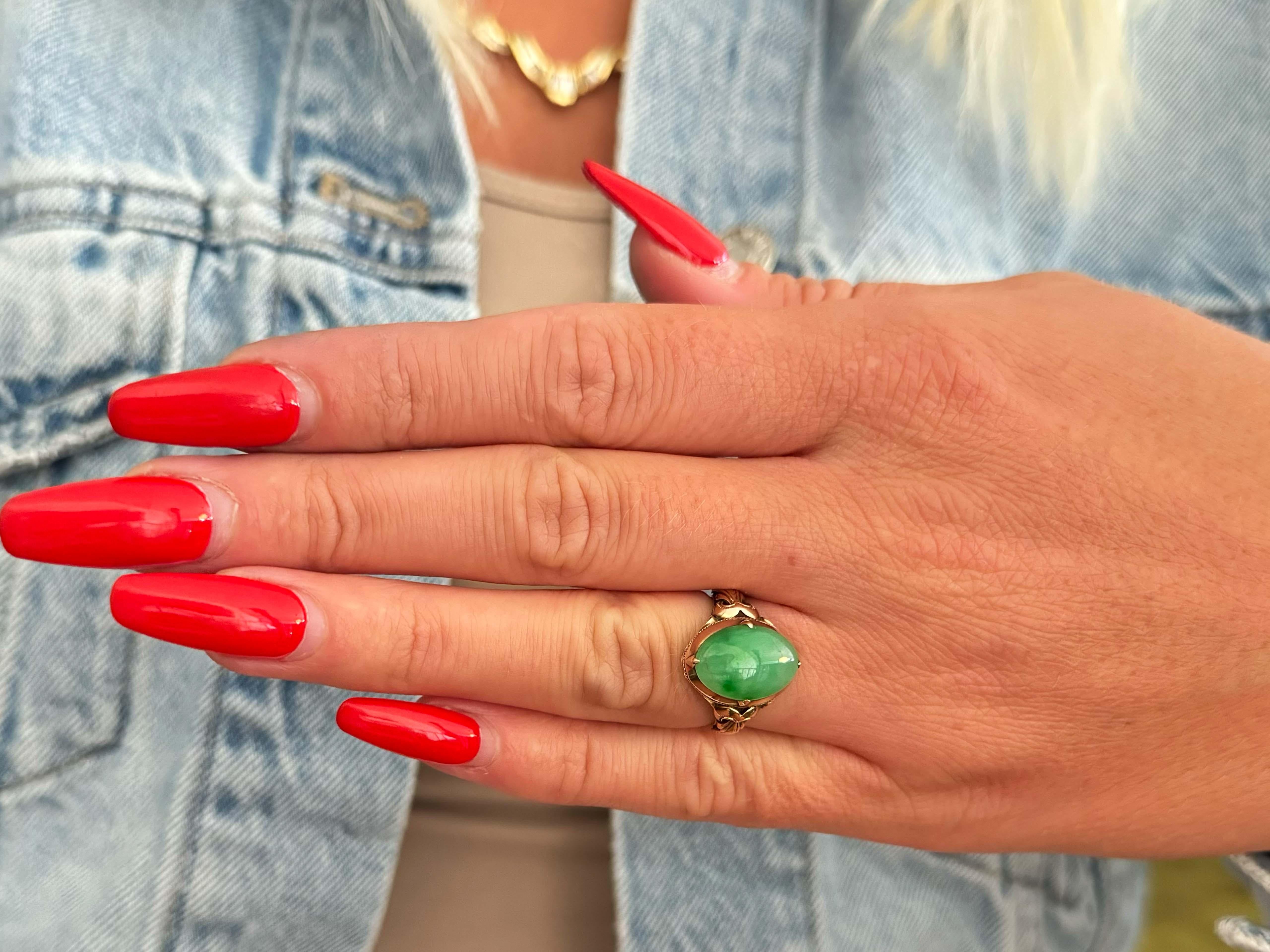 Item Specifications:

Metal: 14k Rose Gold 

Style: Statement Ring

Ring Size: 5.25 (resizing available for a fee)

Total Weight: 2.9 Grams

Gemstone Specifications:

Center Gemstone: Jadeite Jade

Shape: Oval

Color: Green

Cut: Cabochon 

Jade