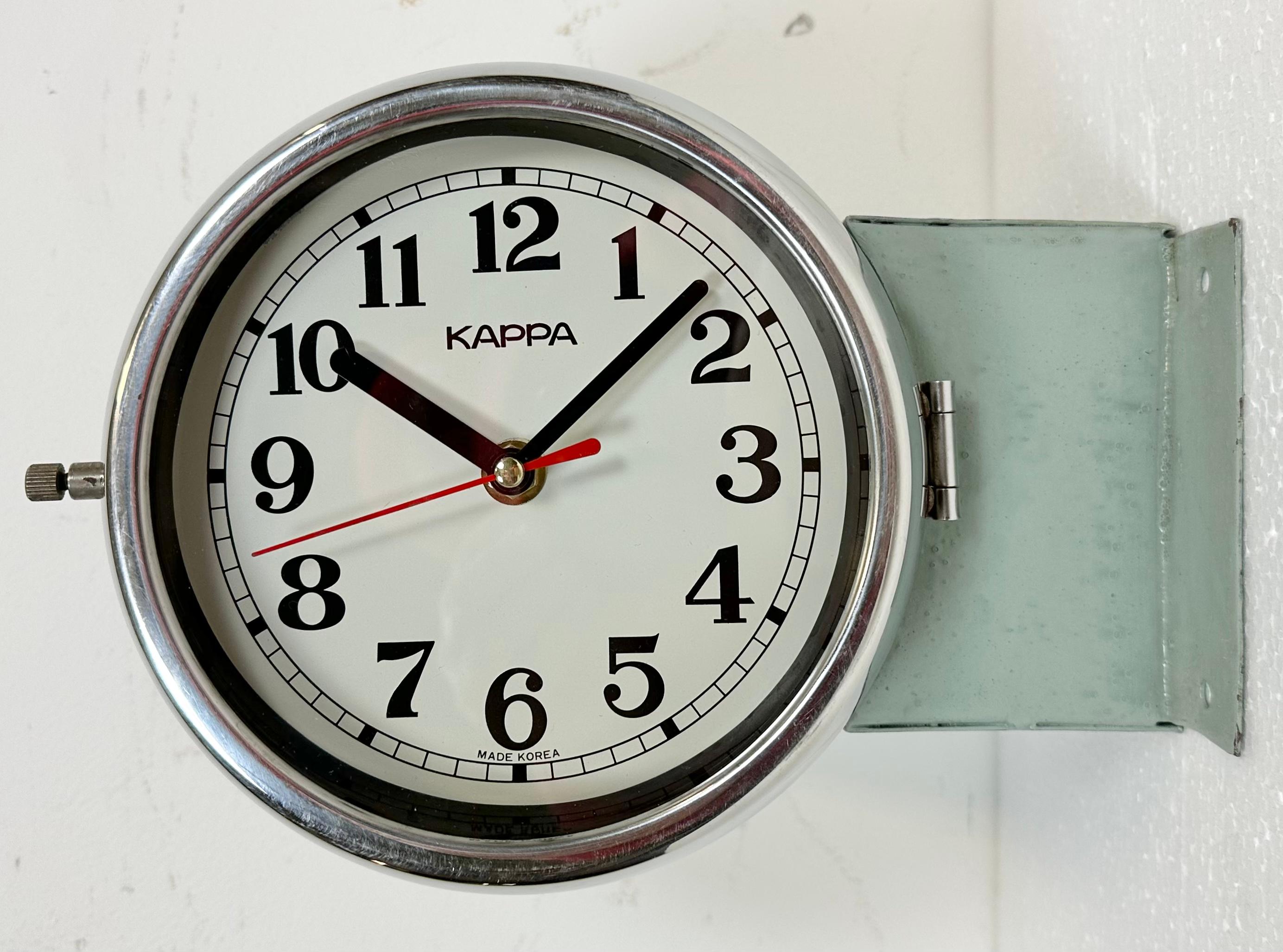 Vintage Industrial Kappa maritime clock made in South Korea during the 1980s . These clocks were used on large tankers and cargo ships. It features a light green metal body, a metal dials and a clear glass covers with chrome frames. Former slave