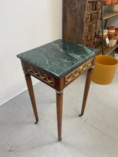 Vintage Green Marble Top Stand on Wheels With Gold Colored Motif of Woman.