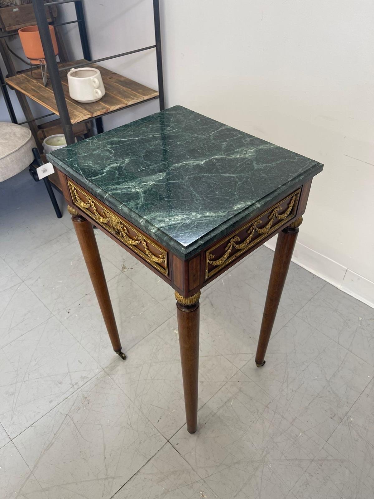 Vintage Green Marble Top Stand on Wheels With Gold Colored Motif of Woman. In Good Condition For Sale In Seattle, WA