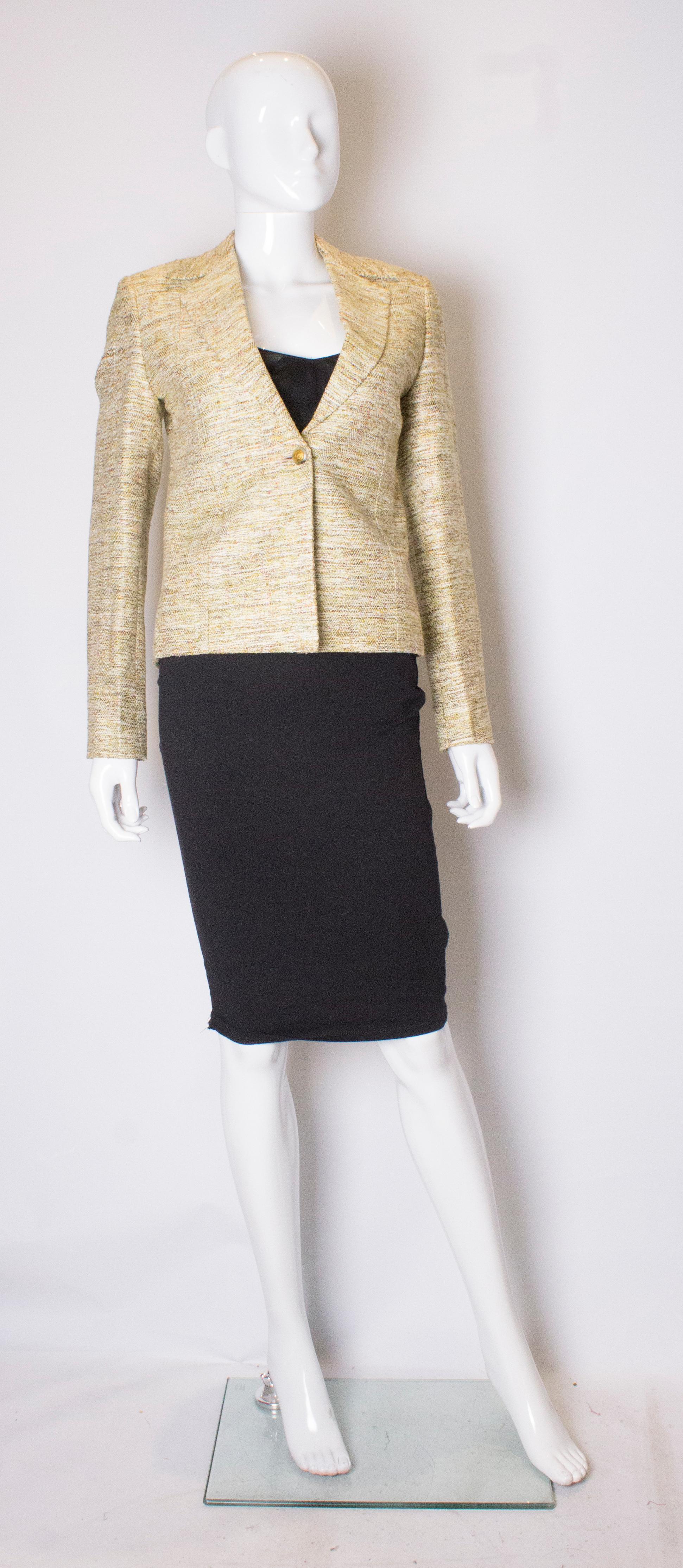 A vintage green tweed like jacket with an attractive collar. The jacket has a one button central fastening and two button cuffs. It is fully lined and has small shoulder pads.